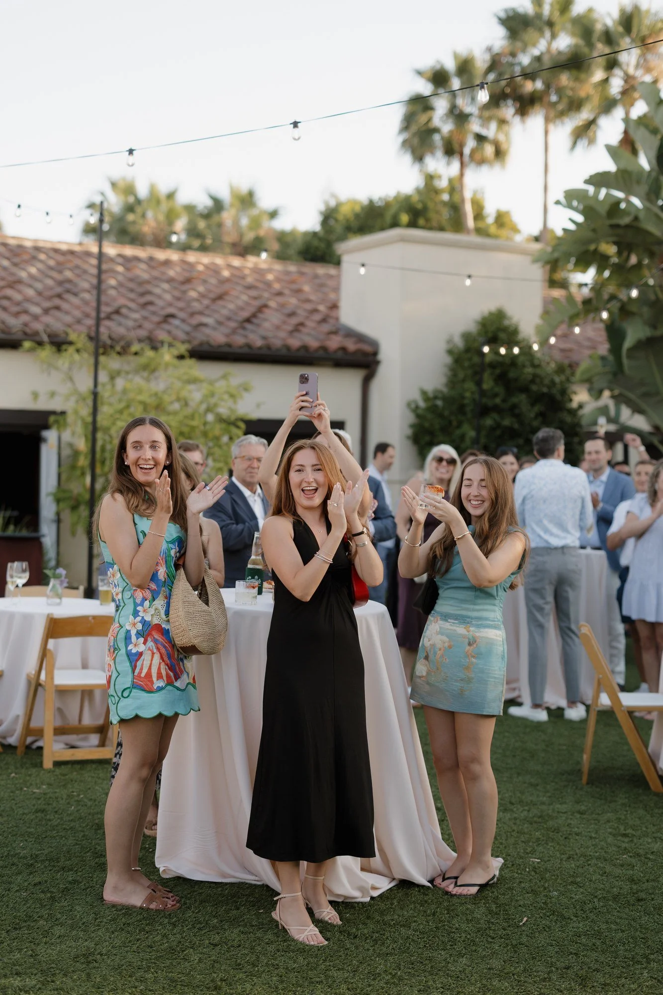 Guests cheering and taking photos as Ryan and Sean arrive at their Estancia rehearsal dinner