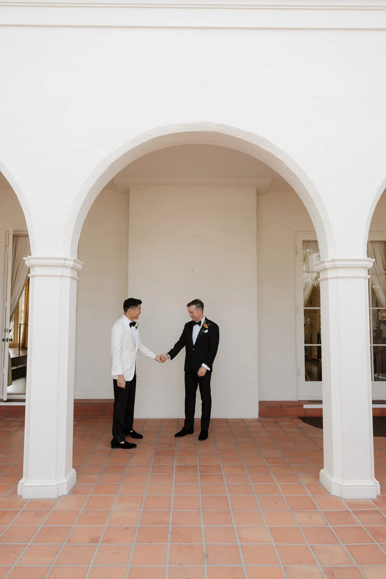 Ryan and Sean's first look under the white arches of the Andalusian Patio at Darlington House
