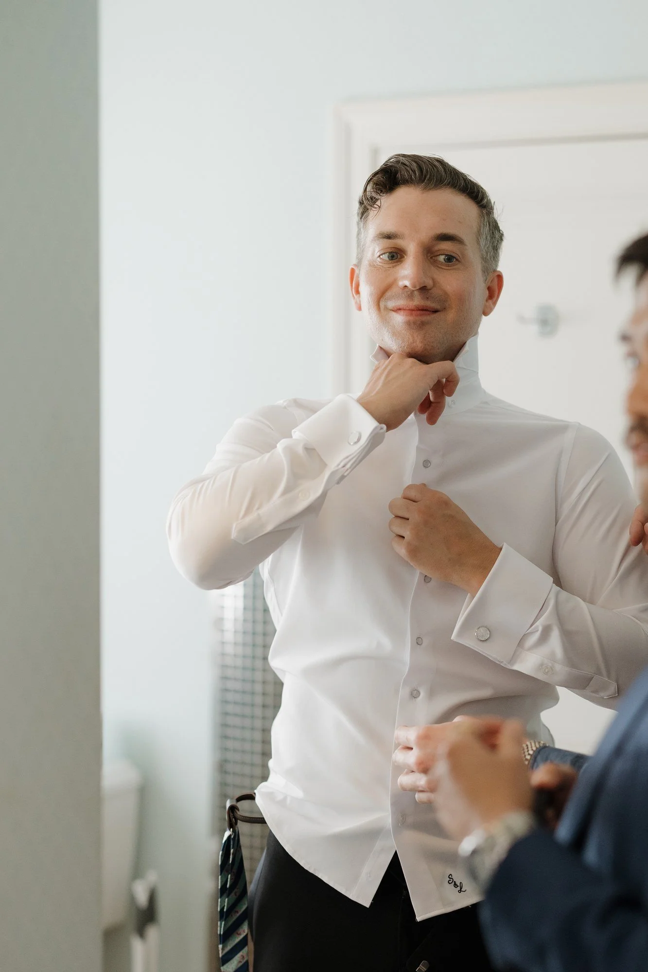 Sean buttoning his shirt while getting ready at Darlington House