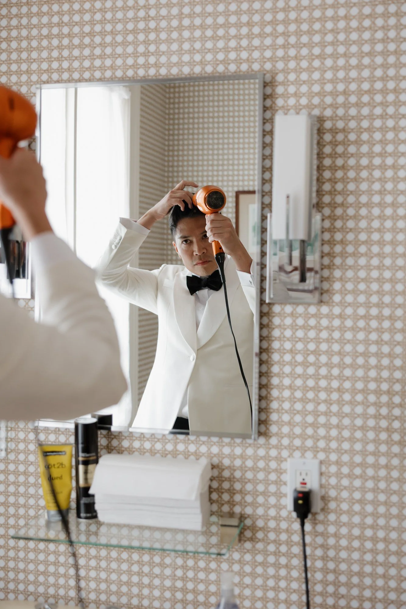 Ryan having his hair styled in the mirror while getting ready at Darlington House