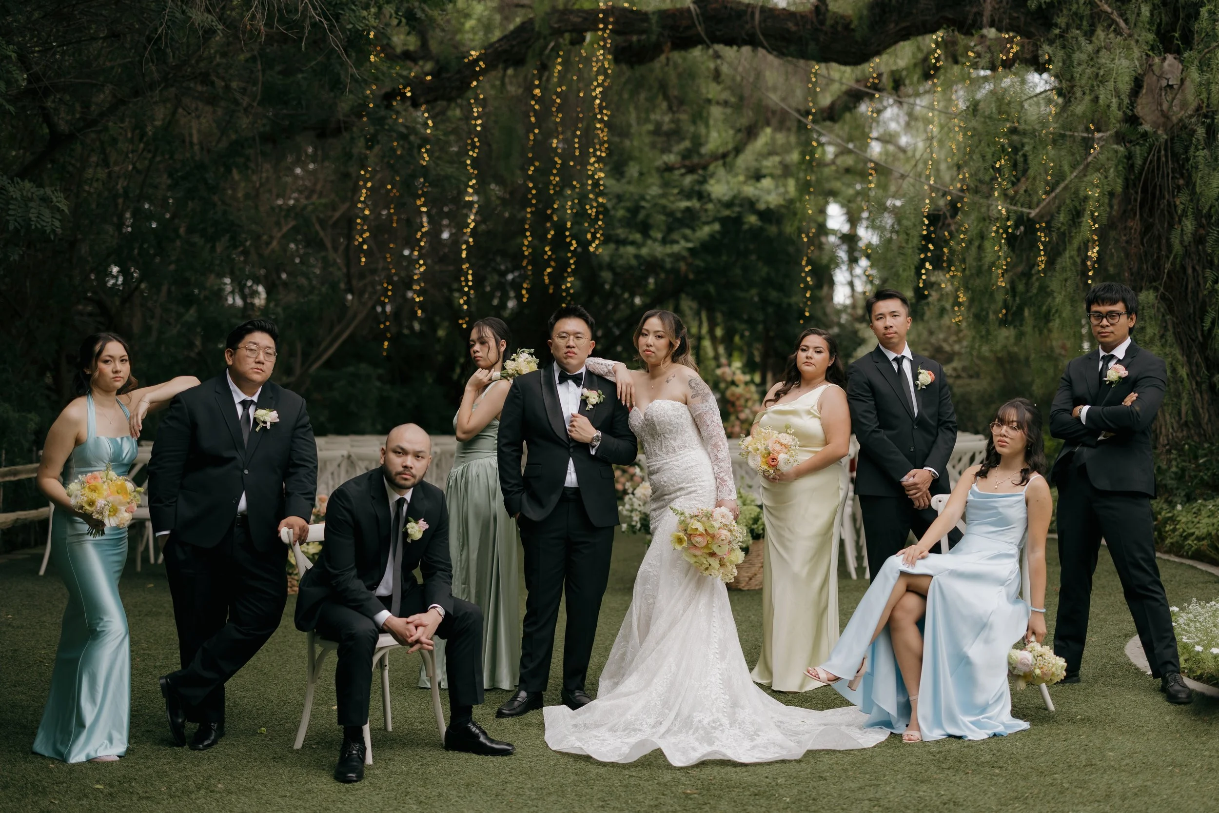 Nancy and Ken with their bridesmaids in pastel gowns and groomsmen in black tuxedos at Green Gables