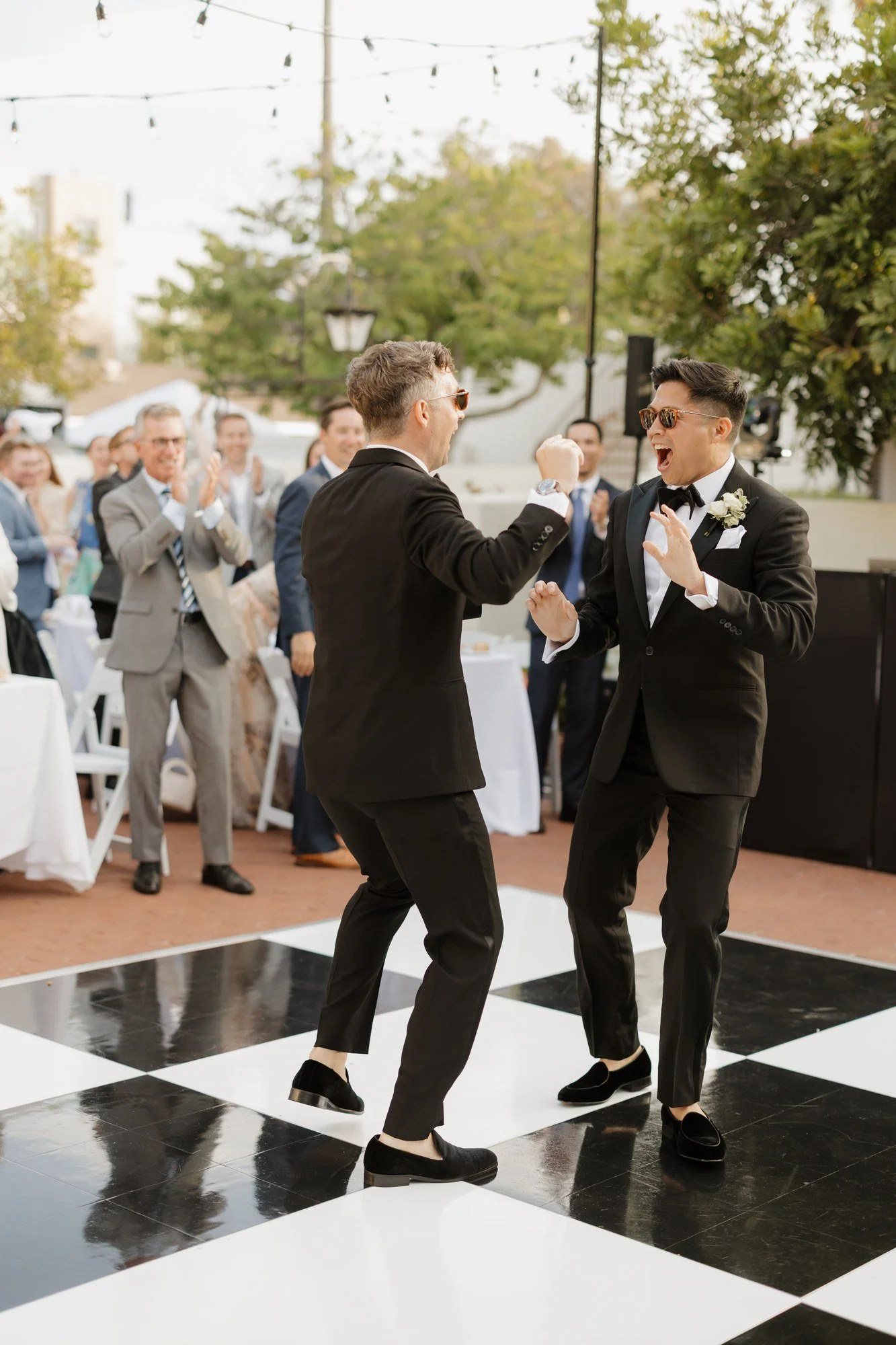 Ryan and Sean celebrating together on the dance floor during their entrance