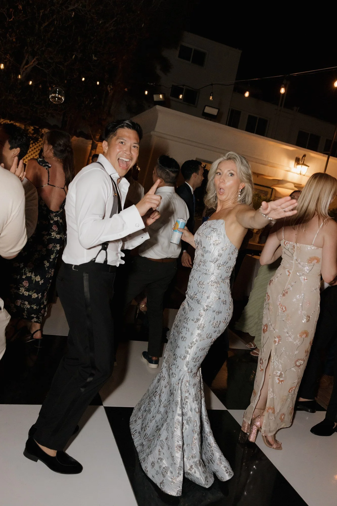 Groom dancing with guests in sparkling gowns at Darlington House