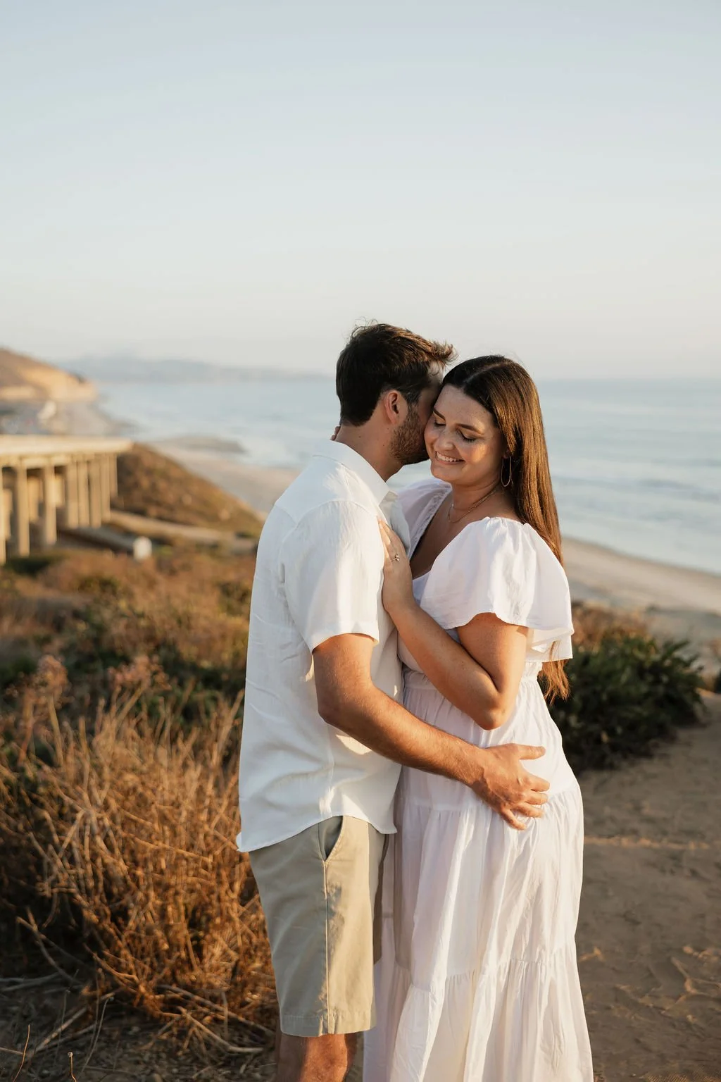 Couple embracing on the bluffs at Torrey Pines