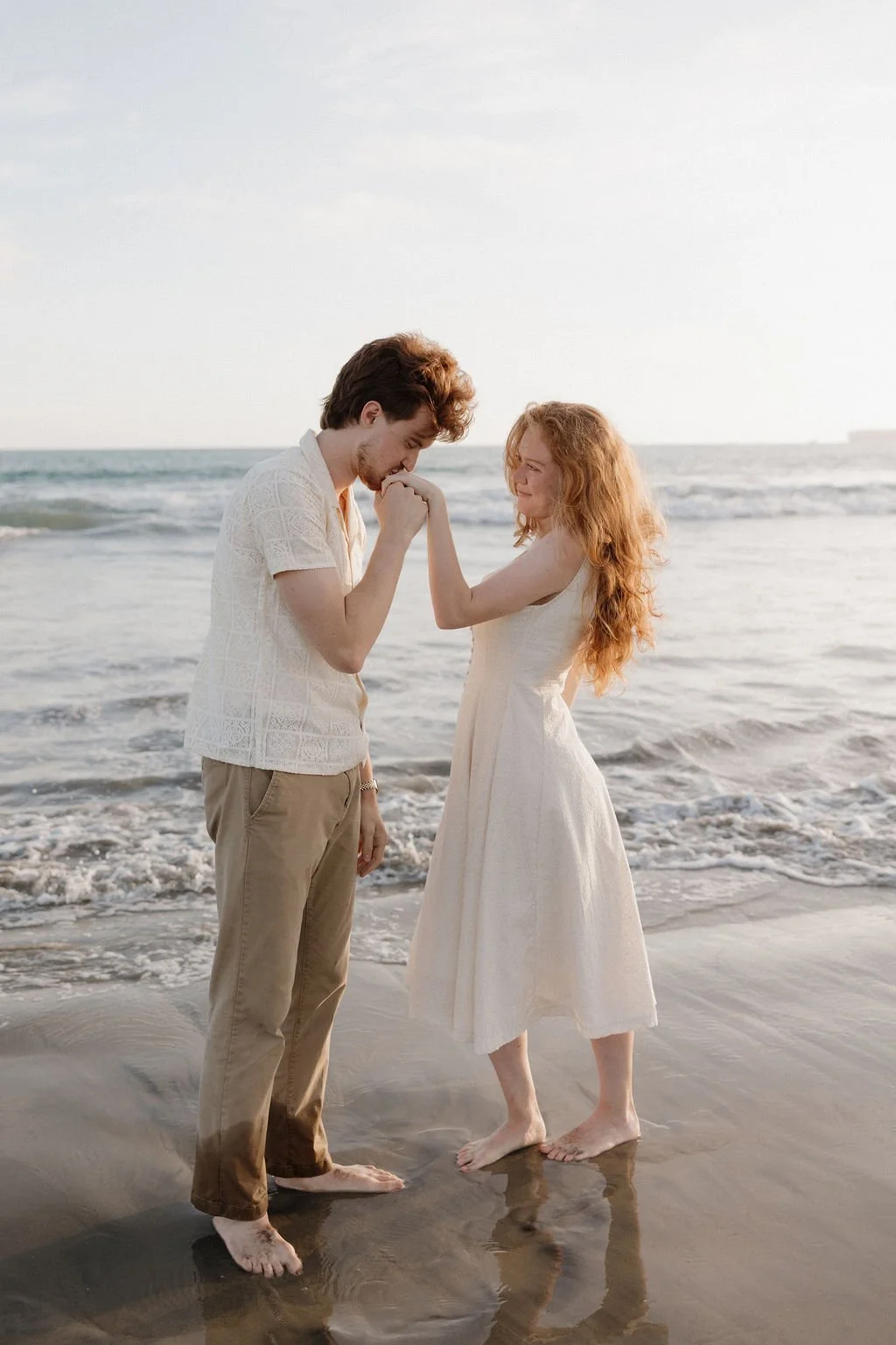 Couple in the shallow surf at Coronado Beach at golden hour