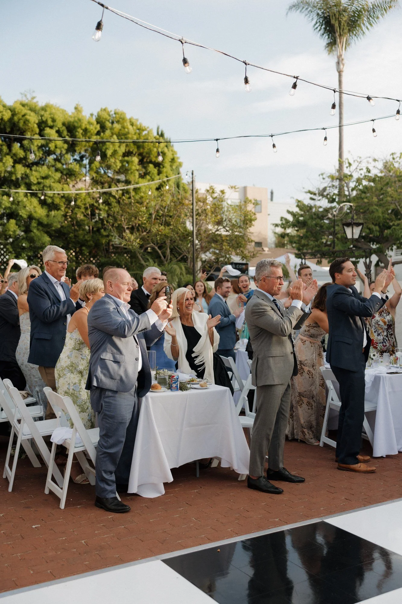 Guests on their feet cheering Ryan and Sean's reception entrance at Darlington House