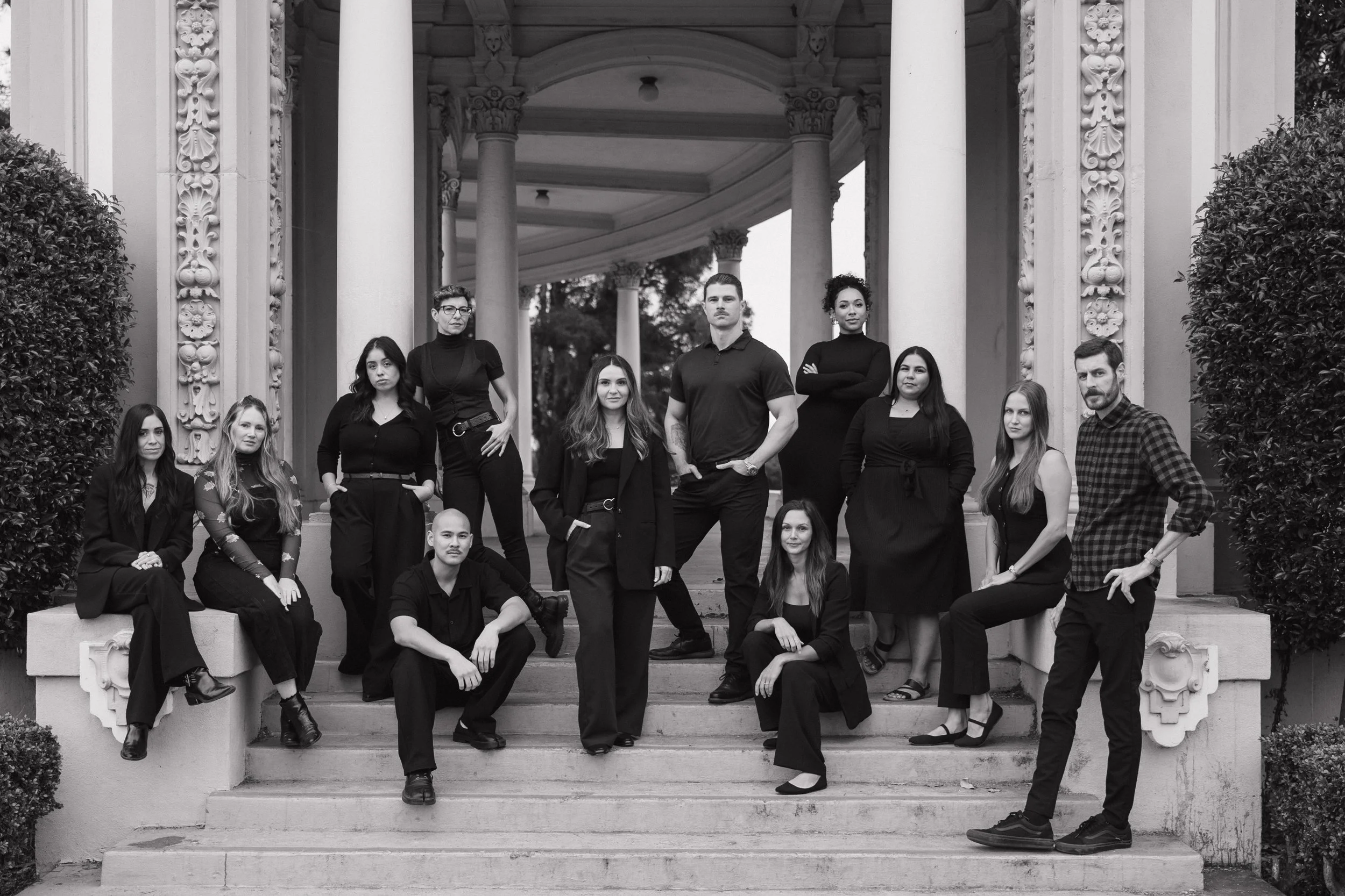 Epic Events Studios photo and video team posed on stone steps under a colonnade – San Diego wedding photography