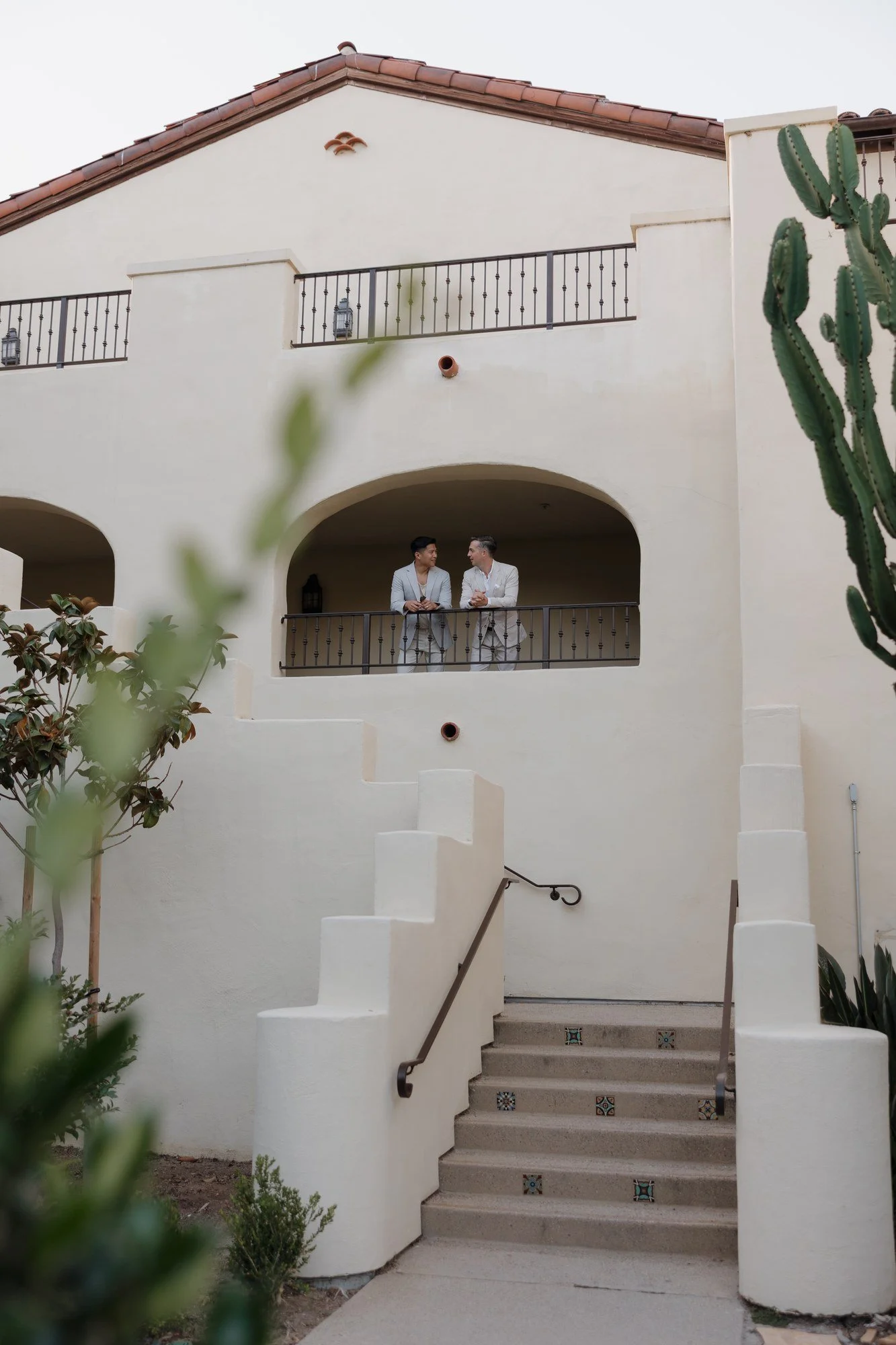 Ryan and Sean on an arched hacienda balcony at Estancia La Jolla