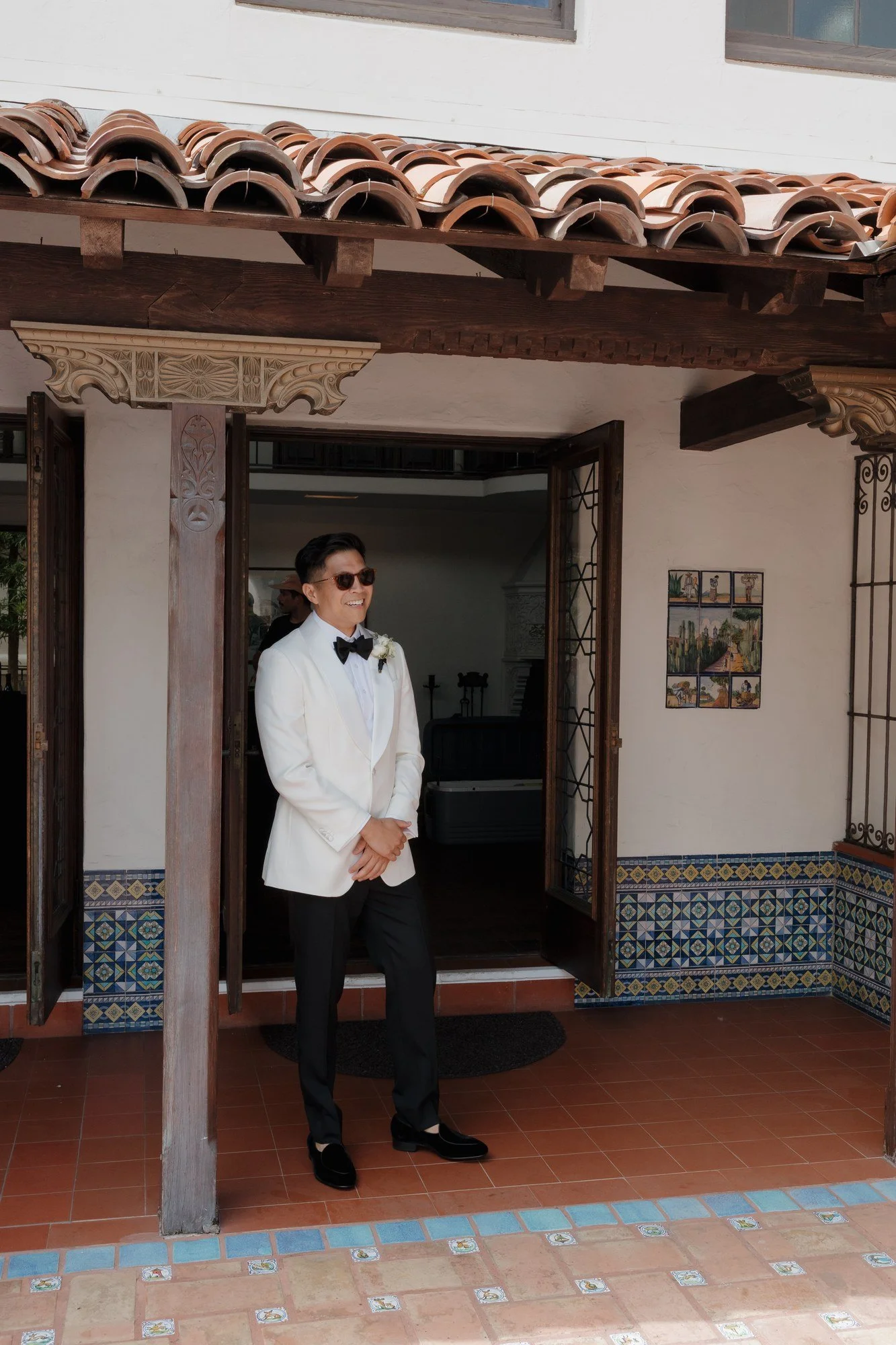 Ryan in his white tuxedo and sunglasses on the tiled patio at Darlington House