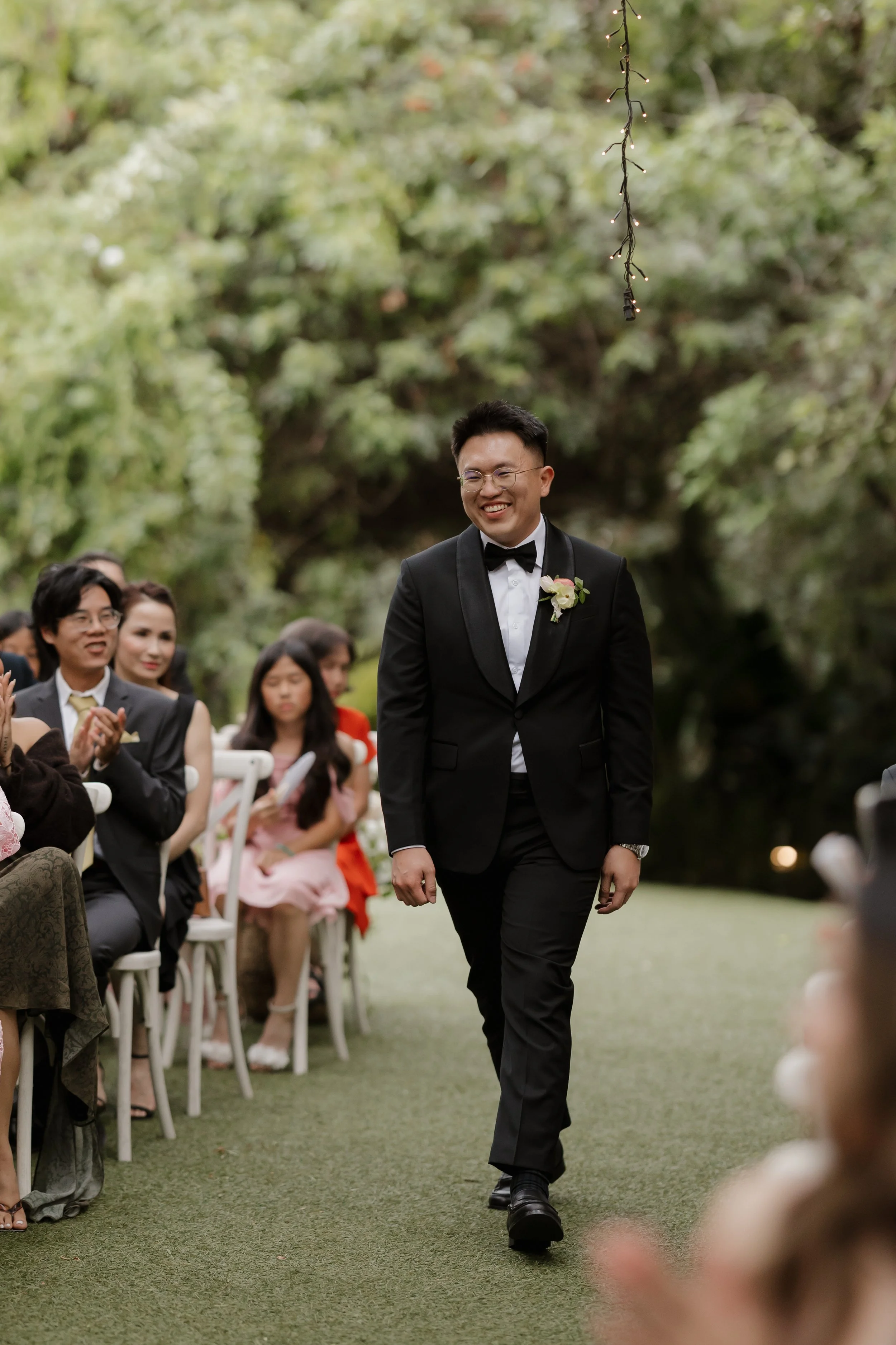 Ken walking down the aisle past guests at his Green Gables wedding ceremony