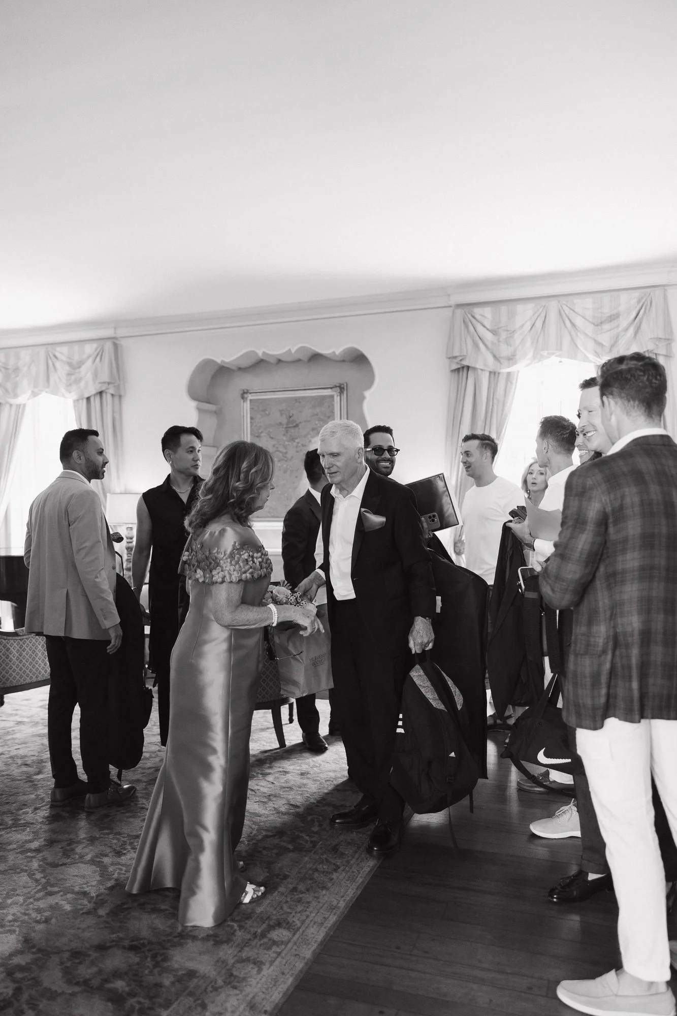 Black and white photo of family and friends gathering in the living room at Darlington House