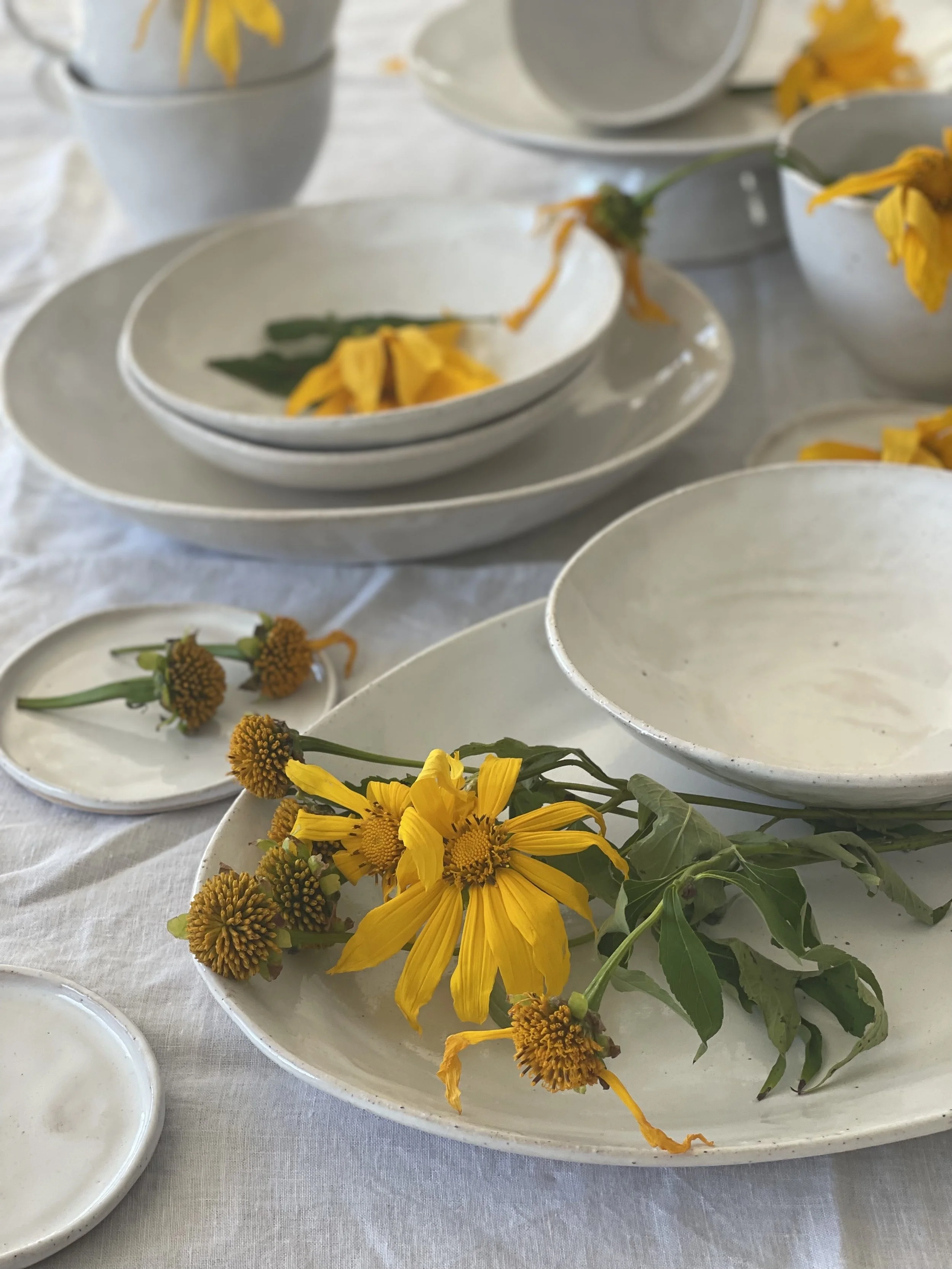 A handcrafted French White X-large Serving Bowl (26cm) by Melissa Lellouche, featuring a glossy white ceramic finish, ideal for serving side dishes, salads, or snacks with elegance.