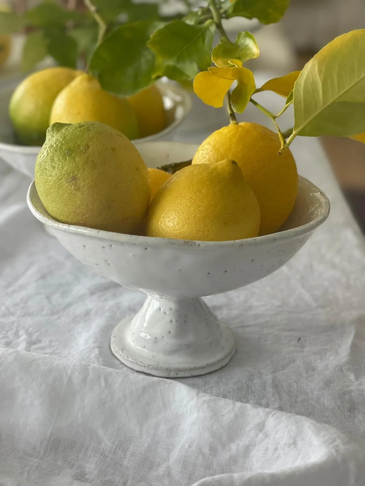 Rome Fruit Pedestal Bowl – handcrafted ceramic pedestal bowl by Melissa Lellouche with natural raw glaze and sculptural base. Ideal as a fruit bowl or centrepiece.