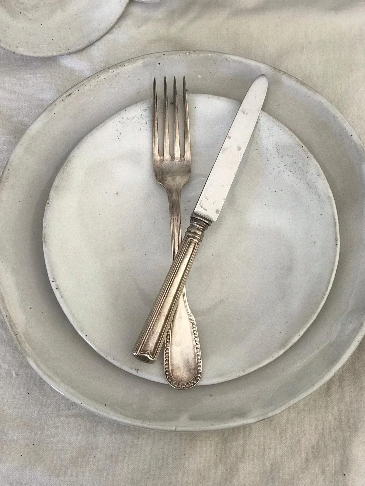 A handcrafted French White Dinner Plate, 26cm round with a glossy ceramic finish, elegantly designed for serving main courses in a beautiful display.