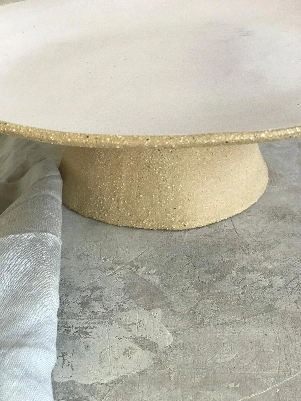 XL handmade ceramic cake stand in matte blush by Melissa Lellouche.