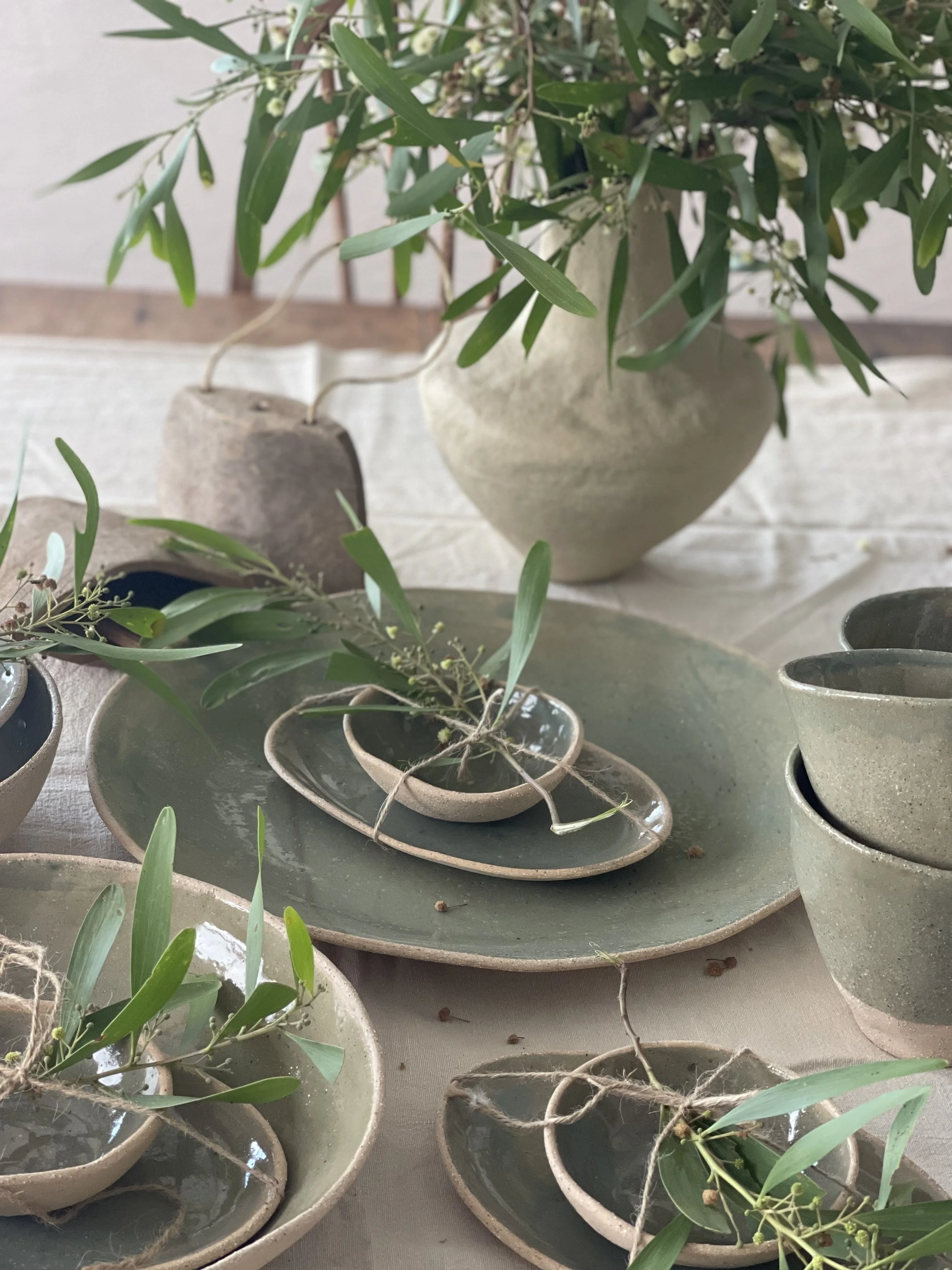 Handmade 38cm Olive Green Ceramic XL Serving Platter by Melissa Lellouche with glossy green-blue drip glaze and raw base.