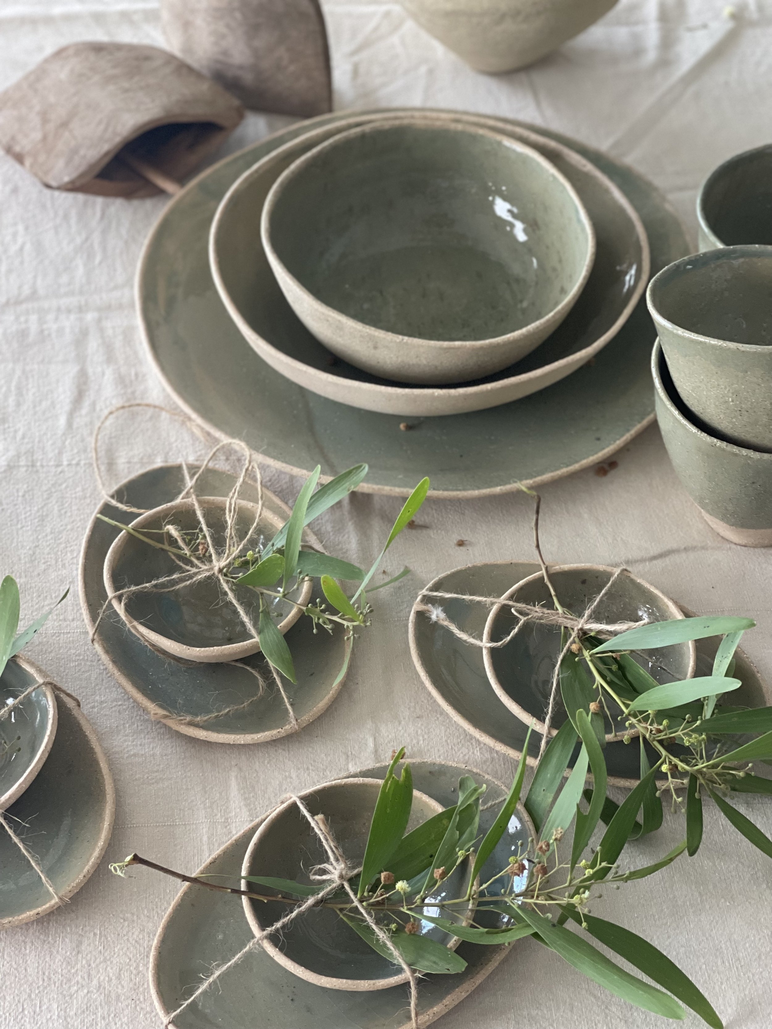 Handmade 22cm Olive Green Oval Side Plate by Melissa Lellouche with gloss glaze finish.