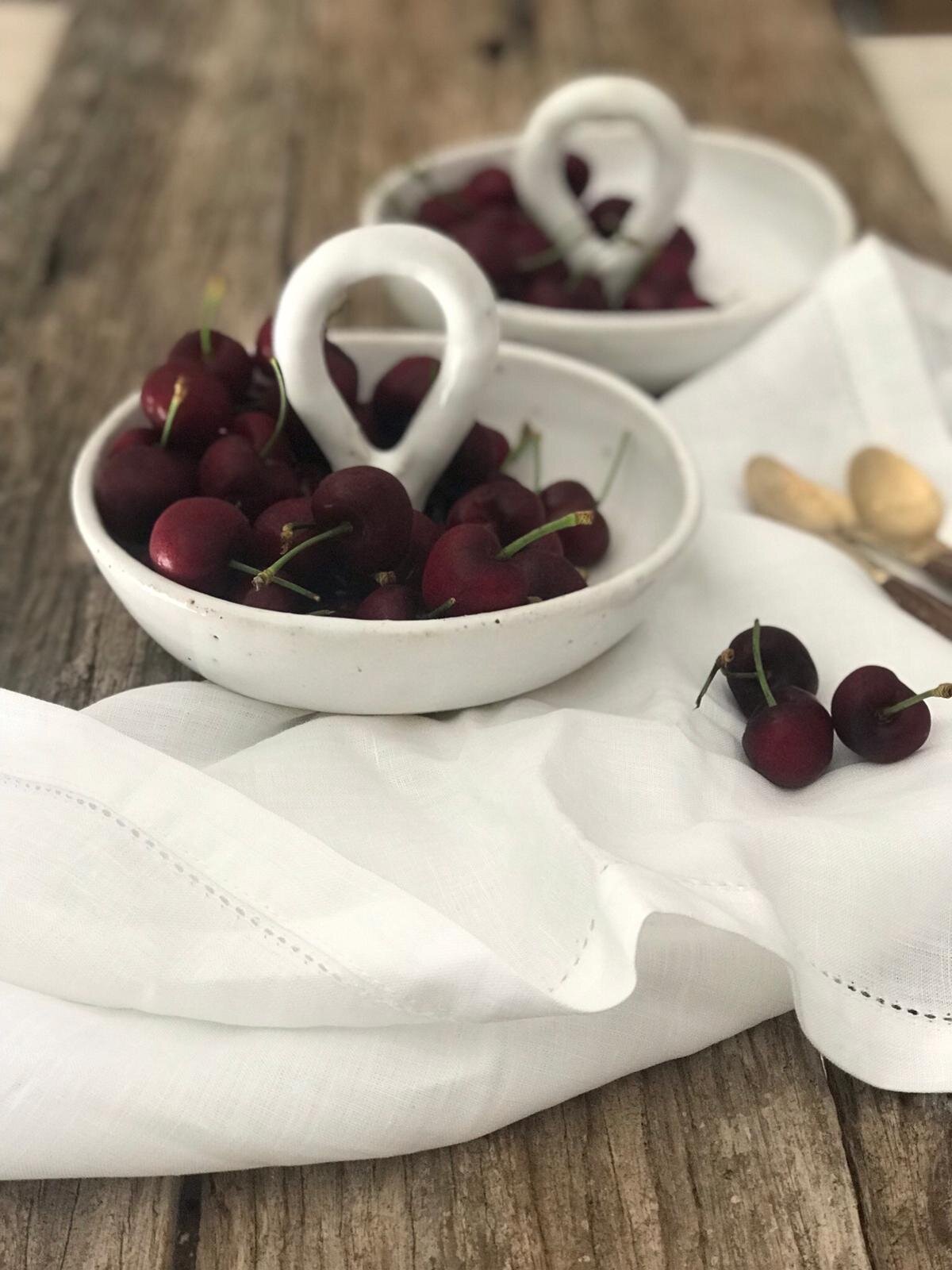 A handcrafted French White Carry Bowl by Melissa Lellouche, featuring a glossy white ceramic finish and minimalist design, perfect for serving or as a décor accent.