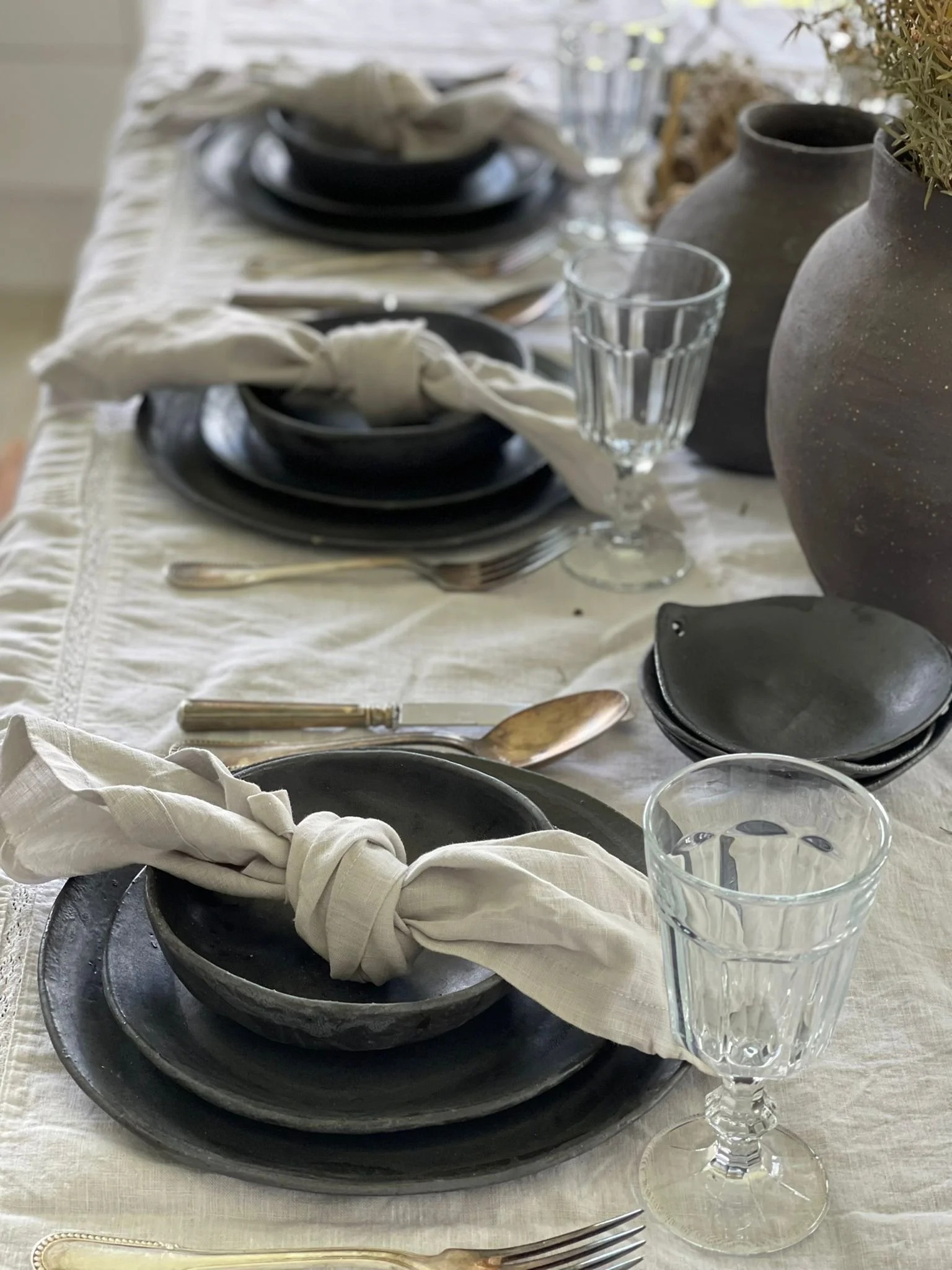 Charcoal Dinner Set – handmade ceramic dinnerware set by Melissa Lellouche featuring charcoal stoneware plates and bowls with a satin matte glaze. Modern, minimalist tableware set.