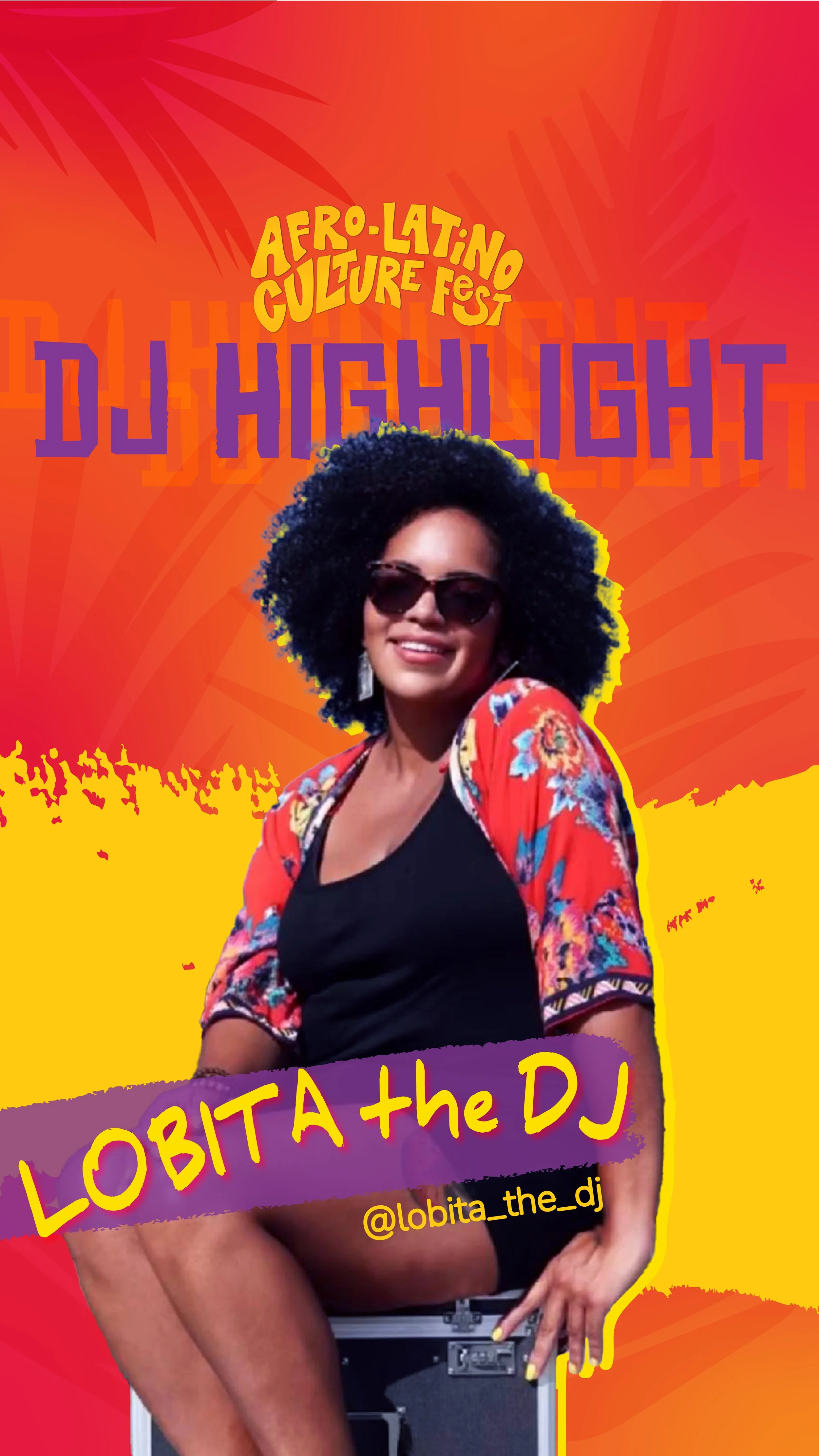 Woman with curly hair, glasses, and hoop earrings smiling at an event. She is wearing a black T-shirt with yellow text that says 'YES! I'SPEAKY SPANISH.' The background features a colorful poster promoting Afro-Latin California.