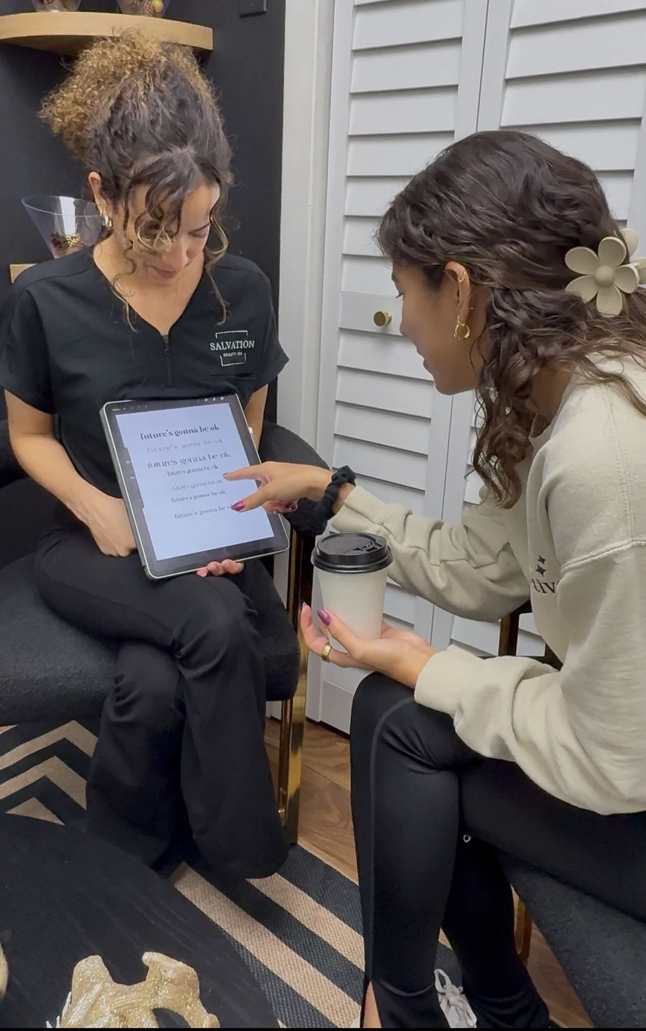 Client consultation at Salvation Beauty Ink in Pembroke Pines, reviewing personalized tattoo or cosmetic tattoo details with a professional artist.