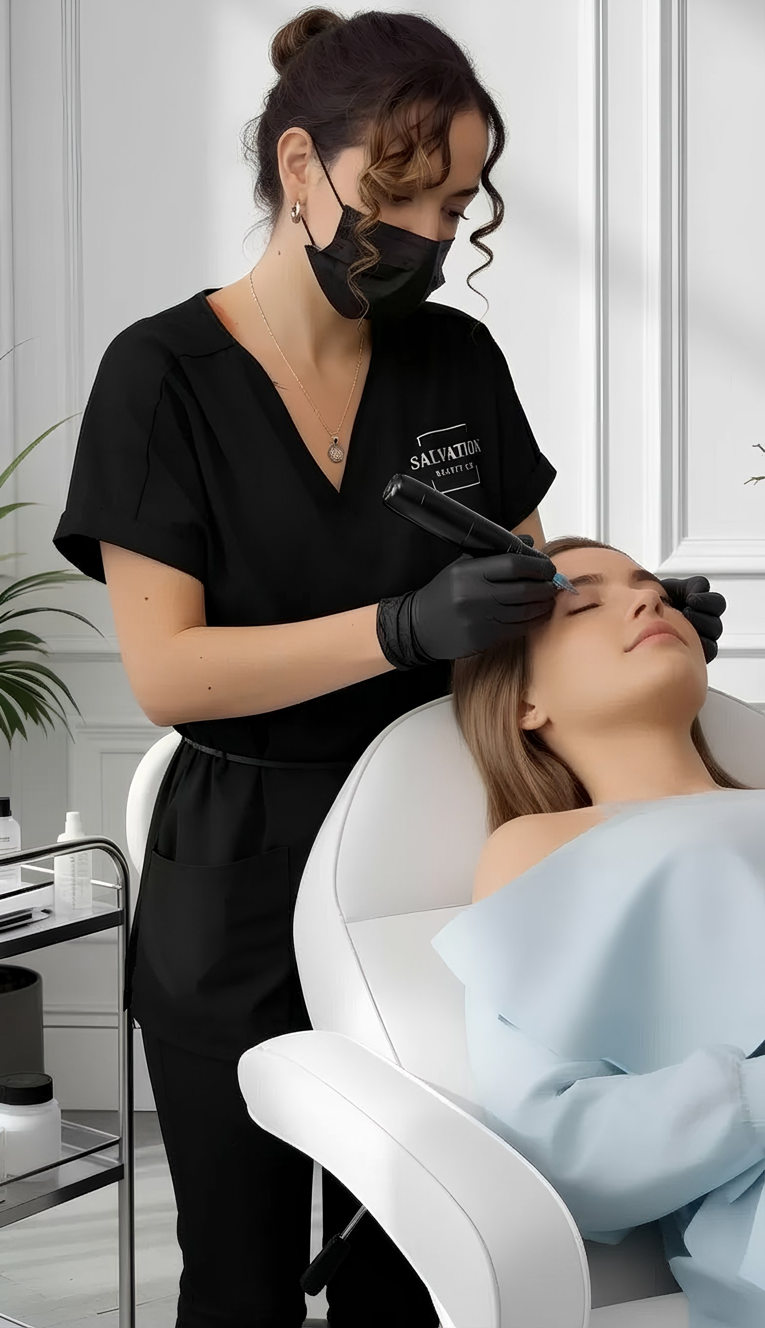 Cosmetic tattoo artist performing a live fine line brow tattoo treatment during professional training in a clean studio environment