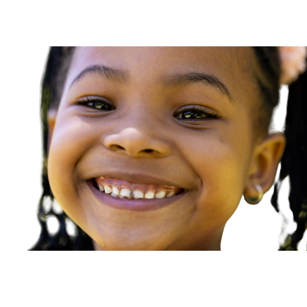 Smiling young girl with newly pierced ears wearing small earrings, showing a happy result after a safe ear piercing