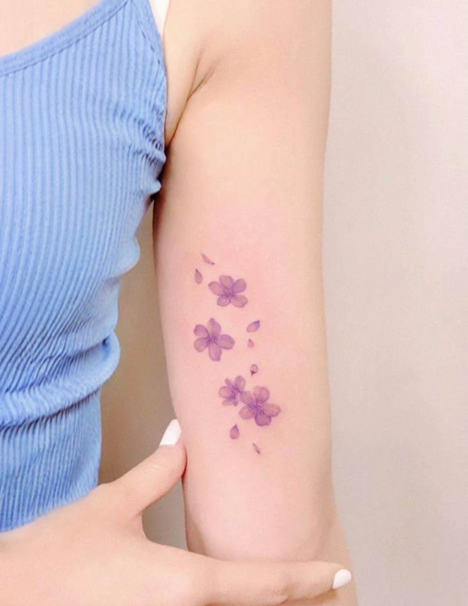 Realistic flowers on the arm of a girl