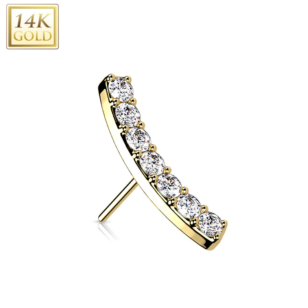 A 14k Gold studded top with seven round diamonds set in a curved row.