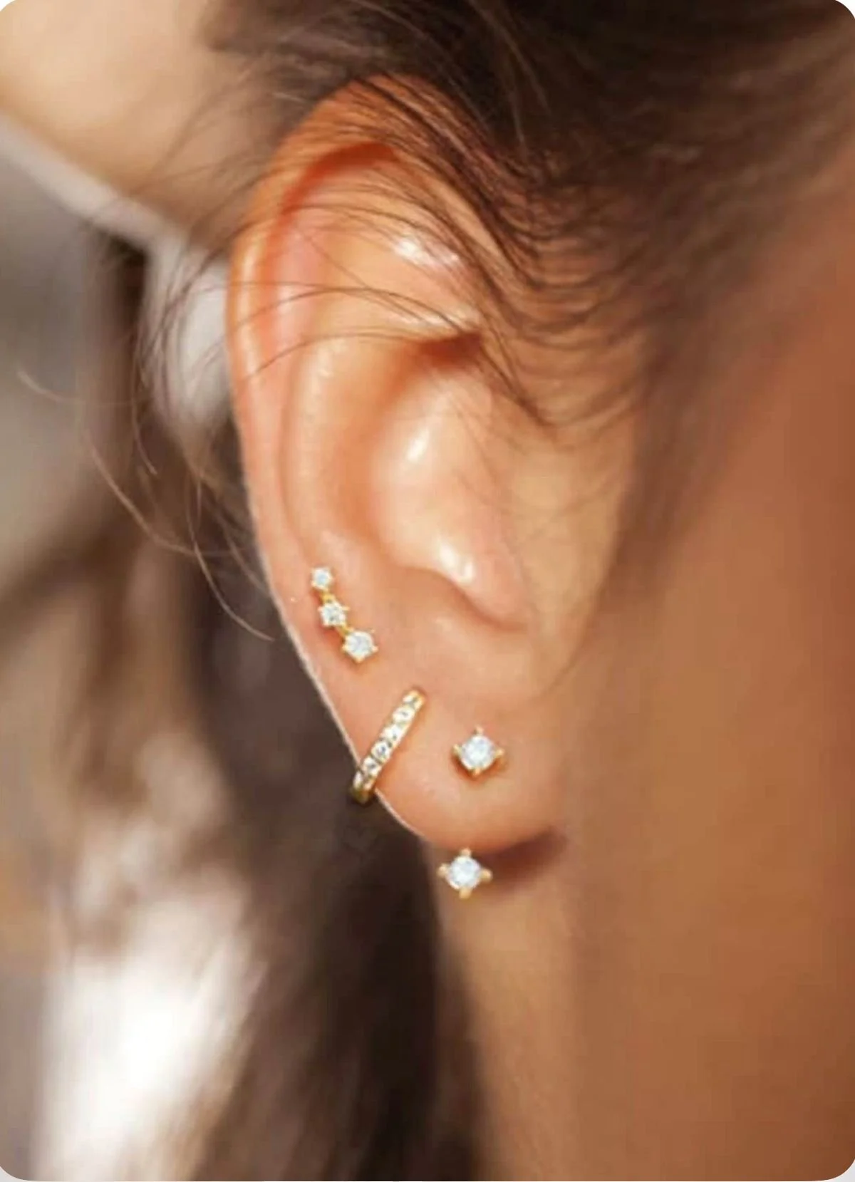 Multiple ear piercings with fine jewelry in professional piercing studio in Pembroke Pines