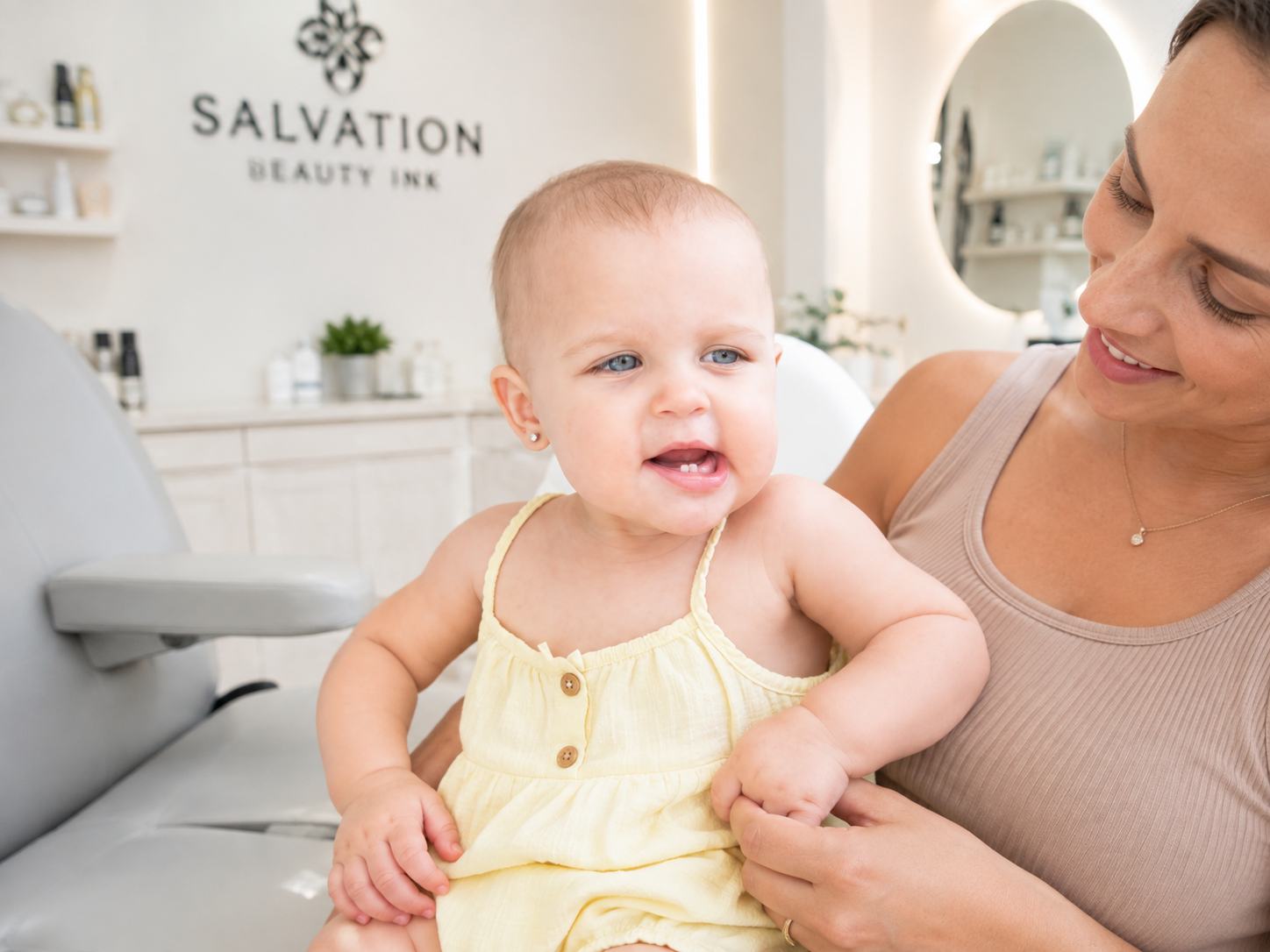 Toddler ear piercing at Salvation Beauty Ink in Pembroke Pines, featuring a child in a clean professional studio.