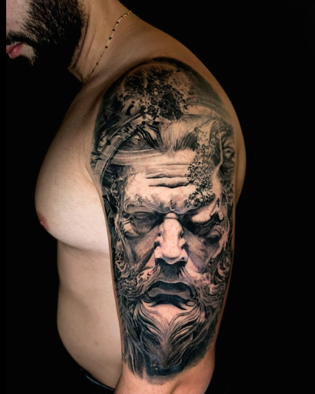 Black and grey realism portrait tattoo on the upper arm created by a professional tattoo artist in Pembroke Pines
