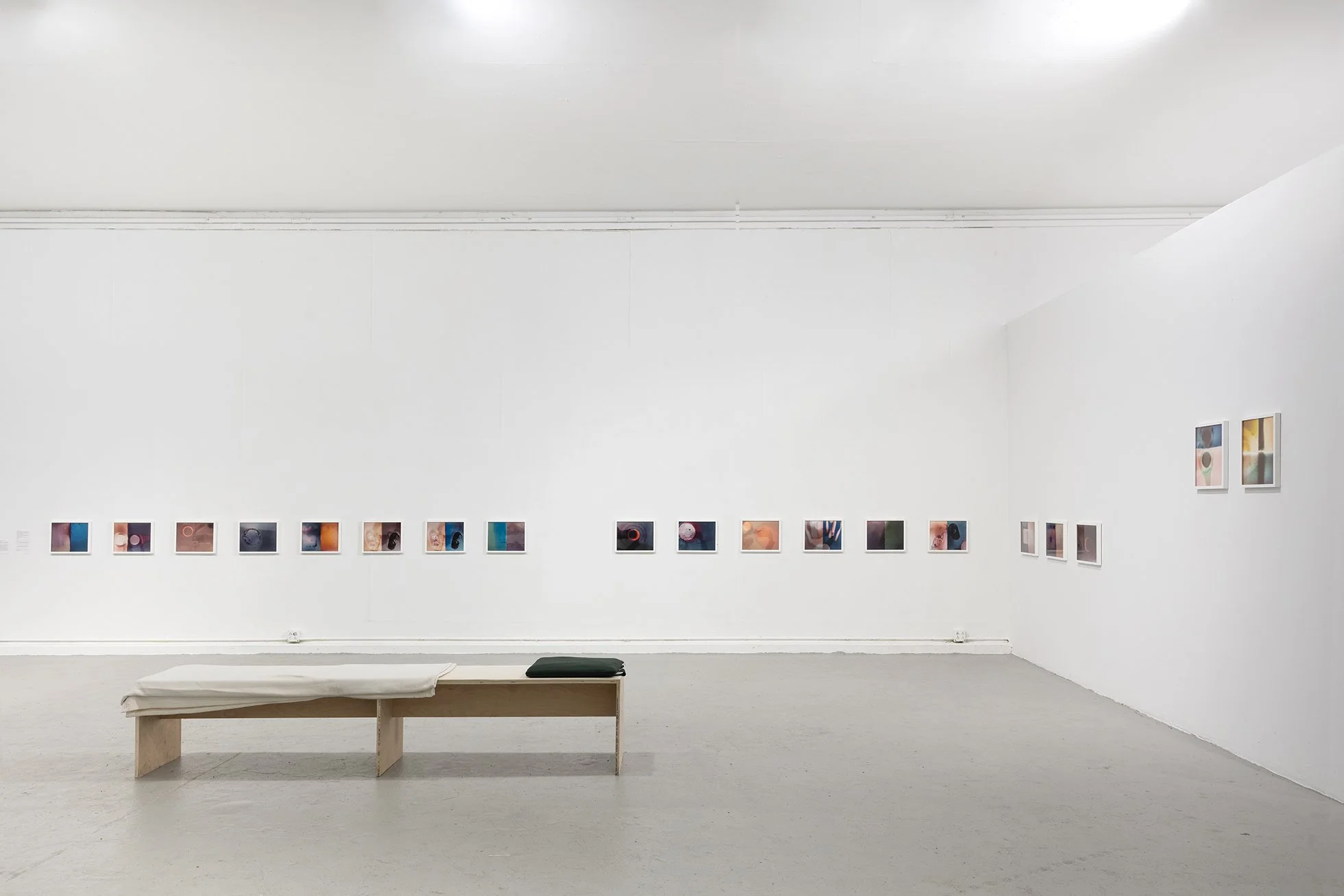 Circle, split, sun, cloud, smoking moon, framed inkjet prints, 11x14 inches, and wood and fabric resting bench, Bard College Exhibition Center, 2025. Photo by Estefanía Landesmann
