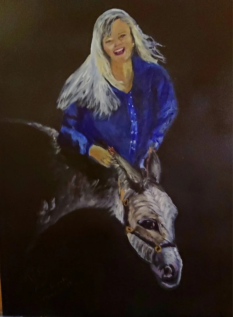 A painting of a woman with long hair, smiling, dressed in a blue shirt, standing next to a donkey
