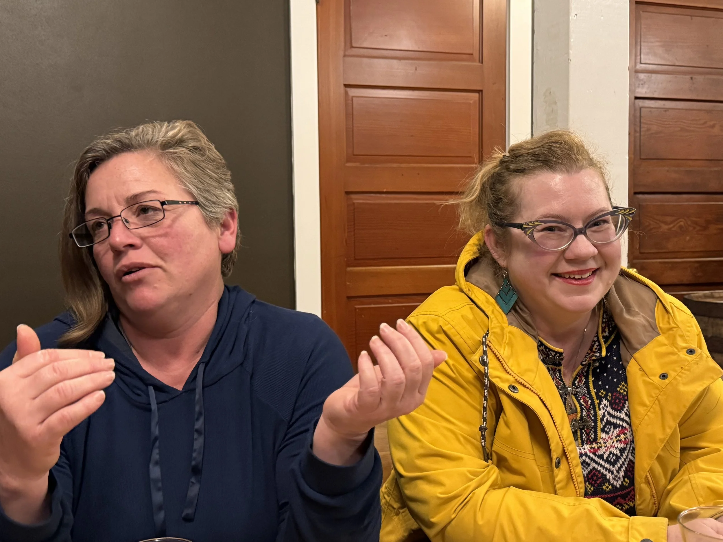 Ahsha mid conversation and Sally smiling at the camera at Scoundrels