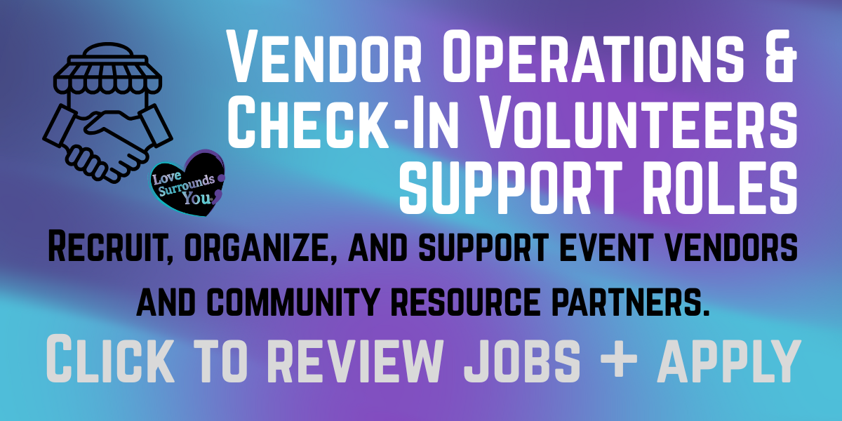 An informational sign with a gradient blue and purple background, featuring a black handshake icon and a heart-shaped sticker that says "Love Surrounds You." The sign invites people to volunteer as vendor operations and check-in volunteers to support event vendors and community partners, with a call-to-action to review jobs and apply.