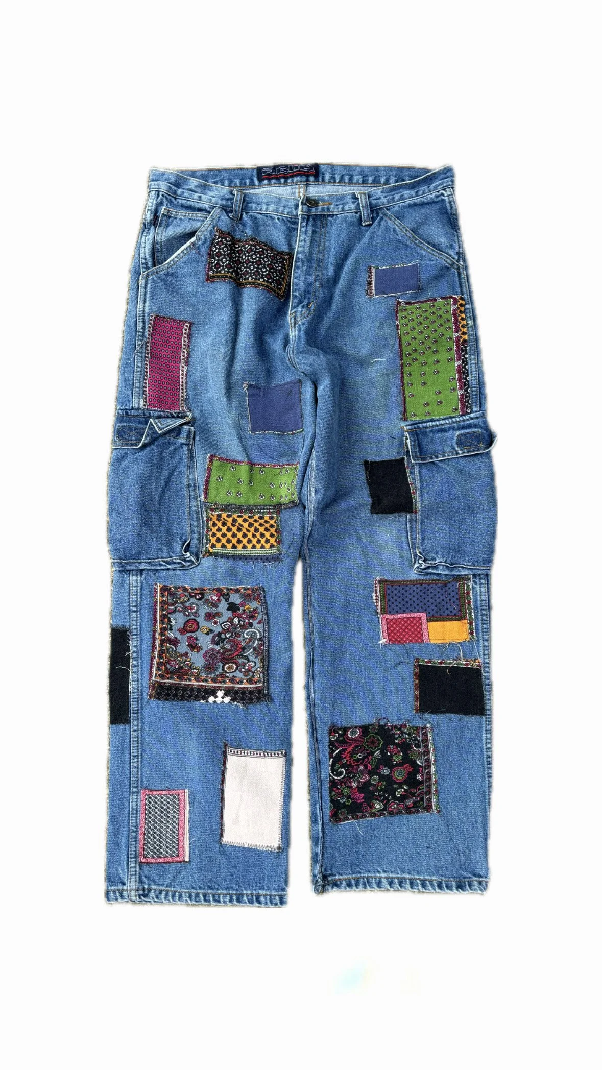 Blue denim jeans decorated with various colorful fabric patches.