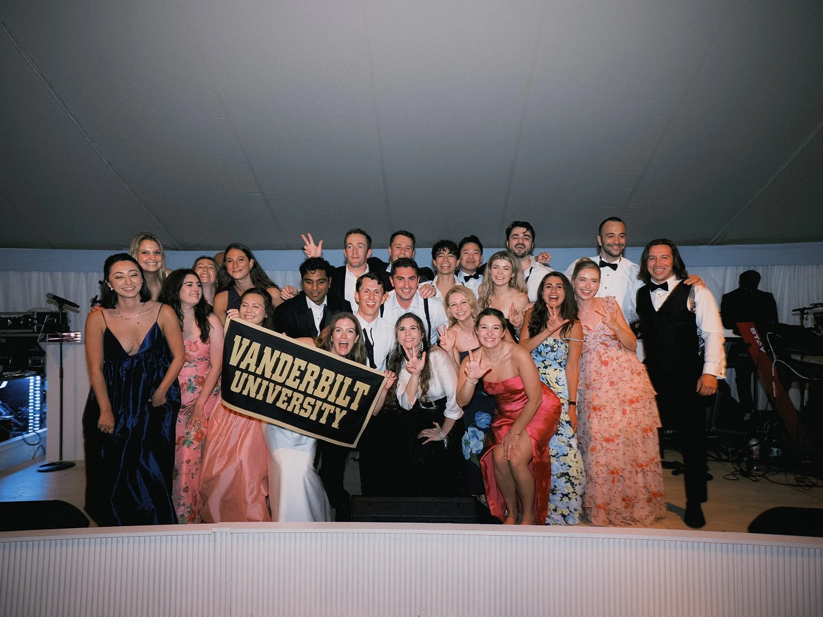 Friends holding a Vanderbilt University banner at the reception at The Maidstone Club