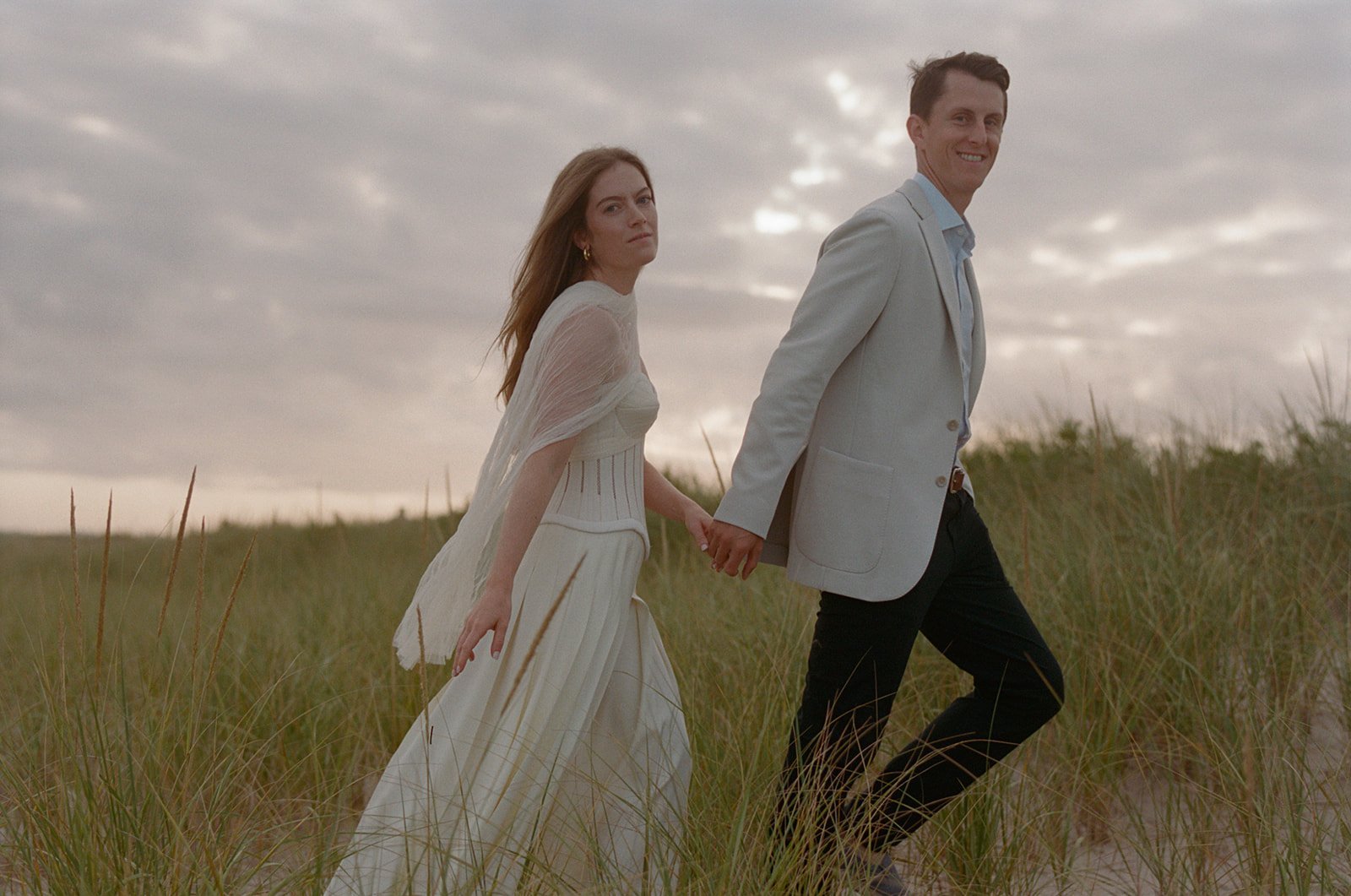 maidstone-club-wedding-venue-couple-walking-dunes-06.jpg
