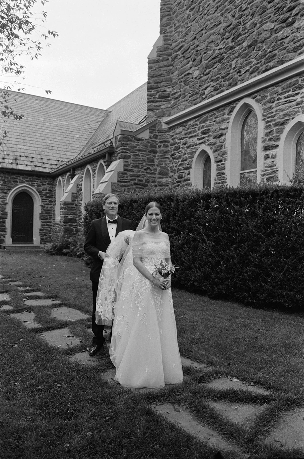 st-lukes-east-hampton-wedding-bride-on-stone-path-bw-16.jpg