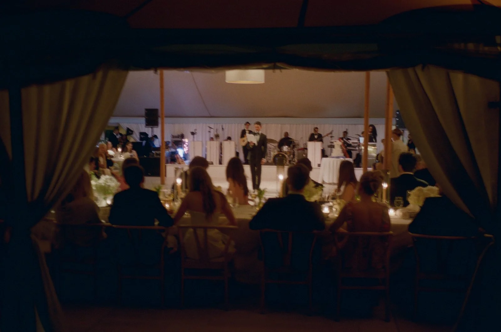 Candlelit dinner in the reception tent at night at The Maidstone Club