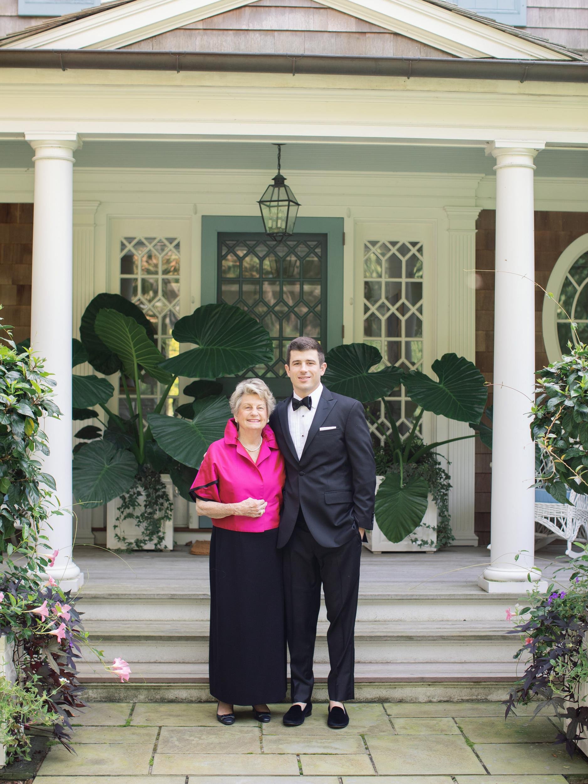 Groom with a family member on the porch steps of an East Hampton home