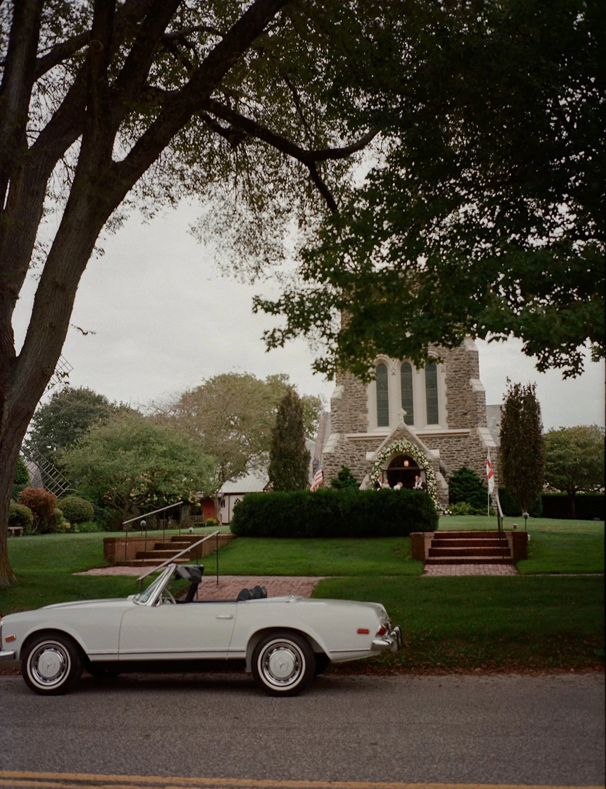 Vintage convertible on James Lane with St. Luke's Episcopal Church behind it