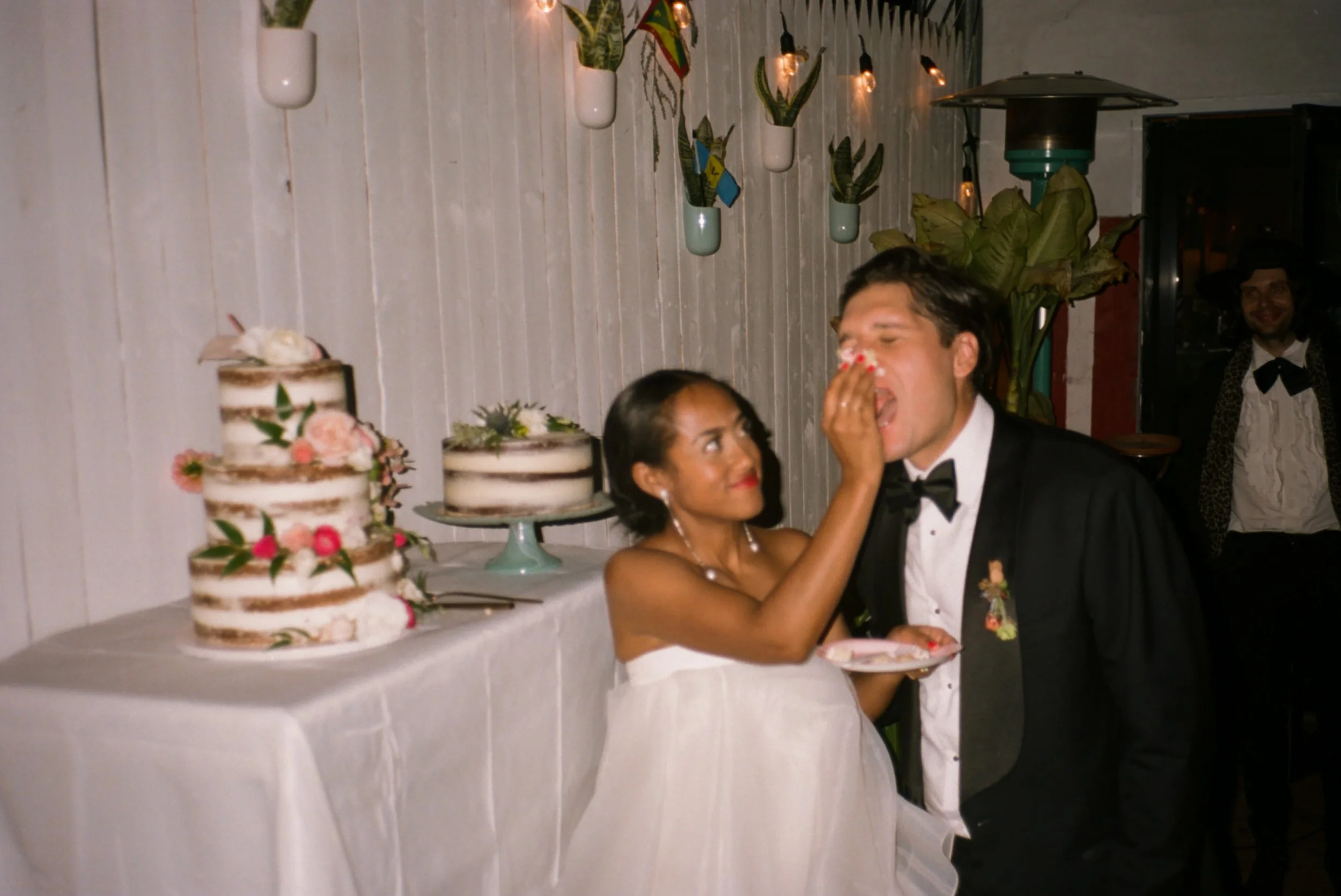 Bride pushing cake into the groom's face at Cafe Erzulie in Brooklyn
