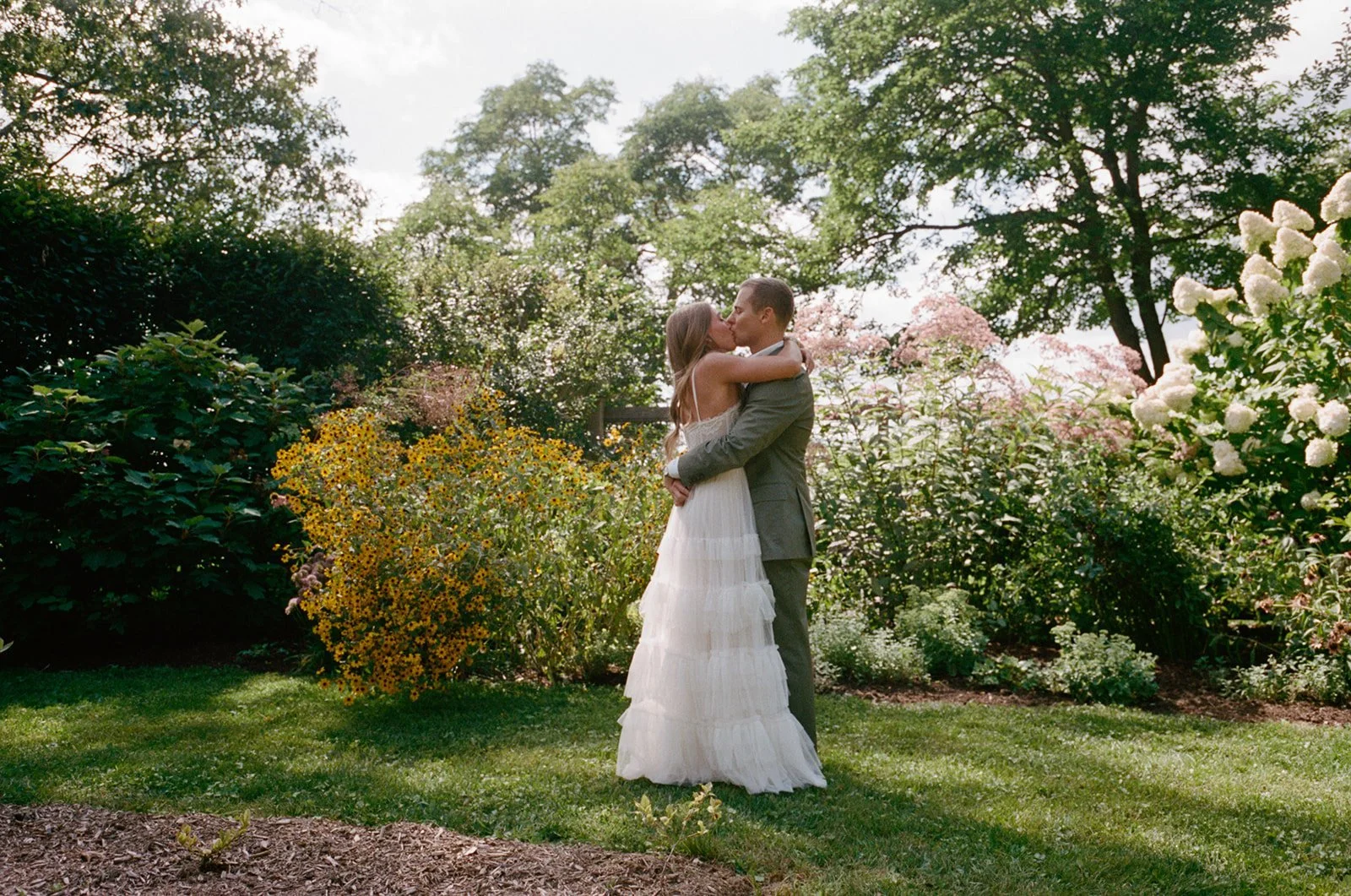 Bride and groom hugging in the garden at Southwood Estate in Germantown, New York
