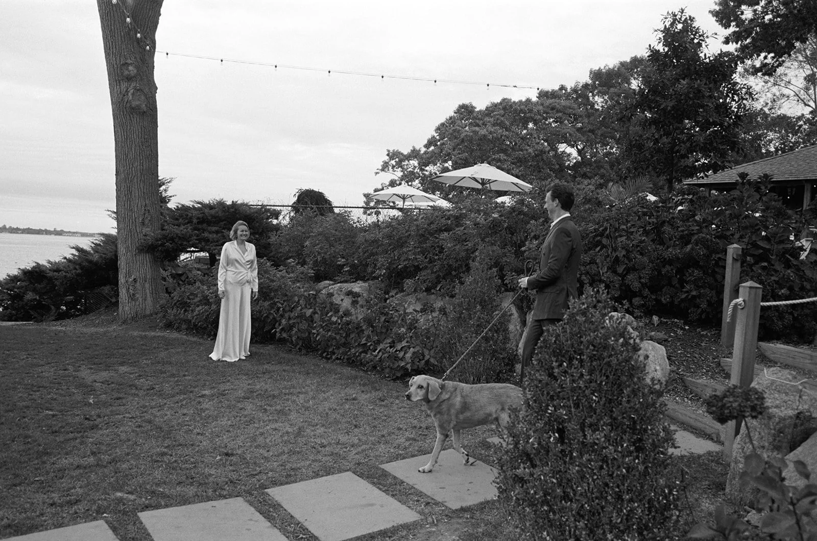 Black and white first look on the lawn at The Pridwin Hotel, with the couple's dog wandering in