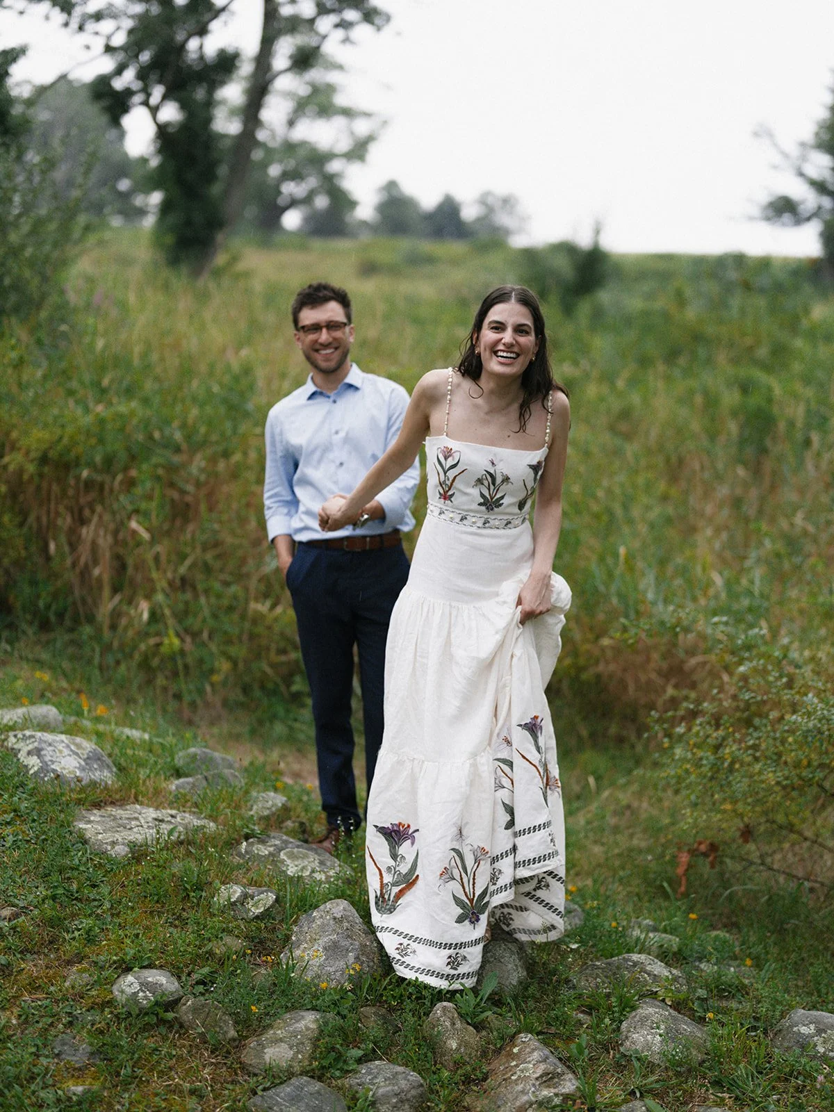 Couple smiling in a wildflower meadow the night before their wedding at Glynwood Farm in Cold Spring, NY