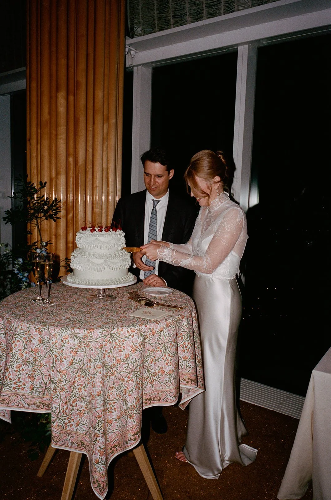 Bride and groom cutting the cake alone in the empty reception room at The Standard, High Line