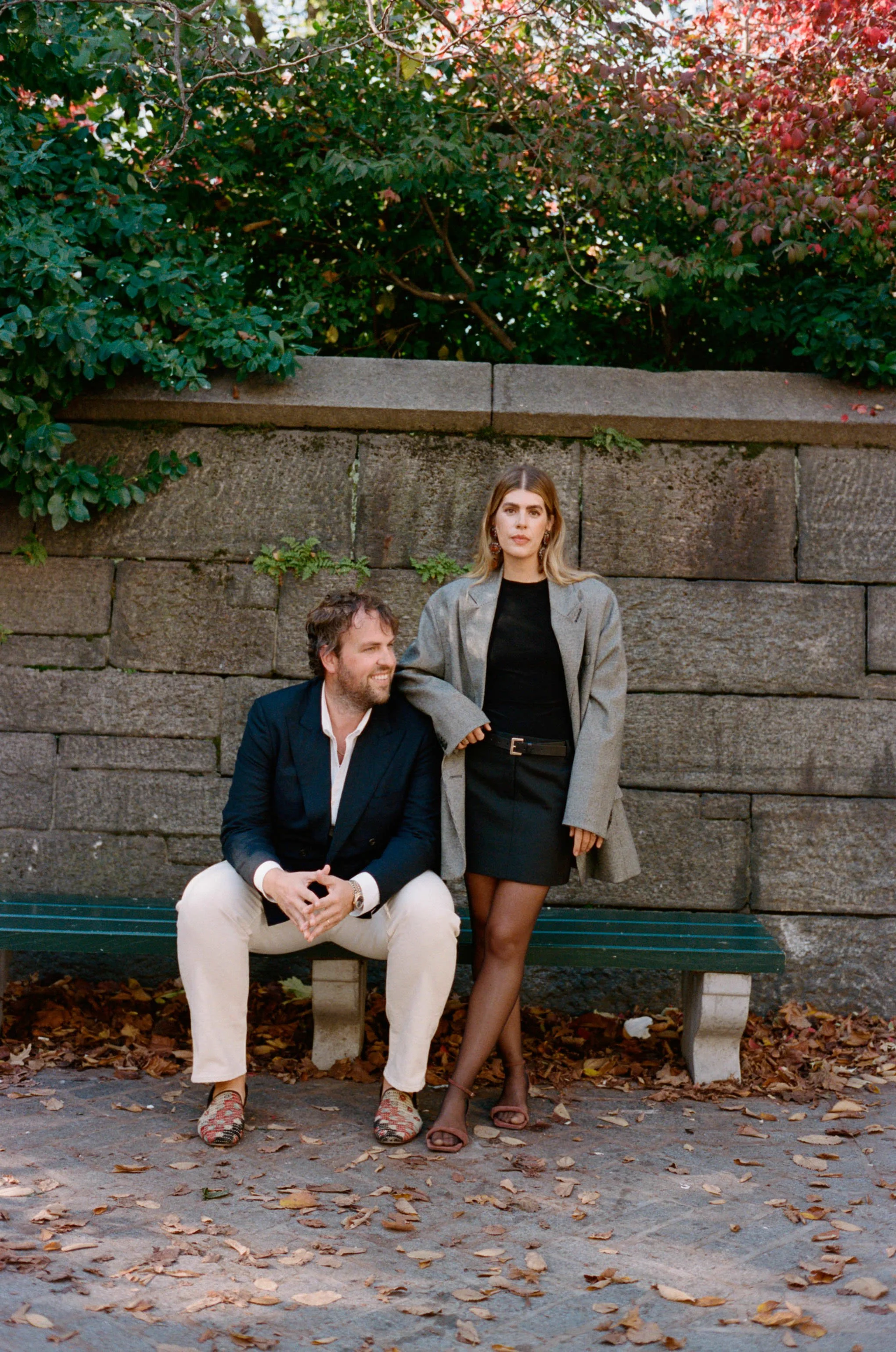 Trent and Dara of by Trent Bailey, wedding photographers based in New York City, on a park bench in the fall