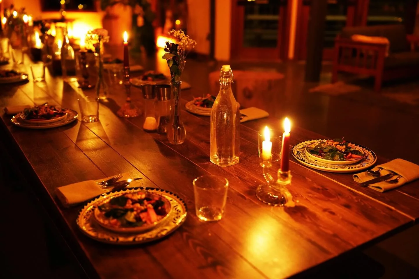 A single long table lit by candlelight, where time slows and conversations unfold. Strangers soften into something familiar. Everyone sits together, not as a symbol, but as a shared experience.

And each time we gather to nourish ourselves, we are re